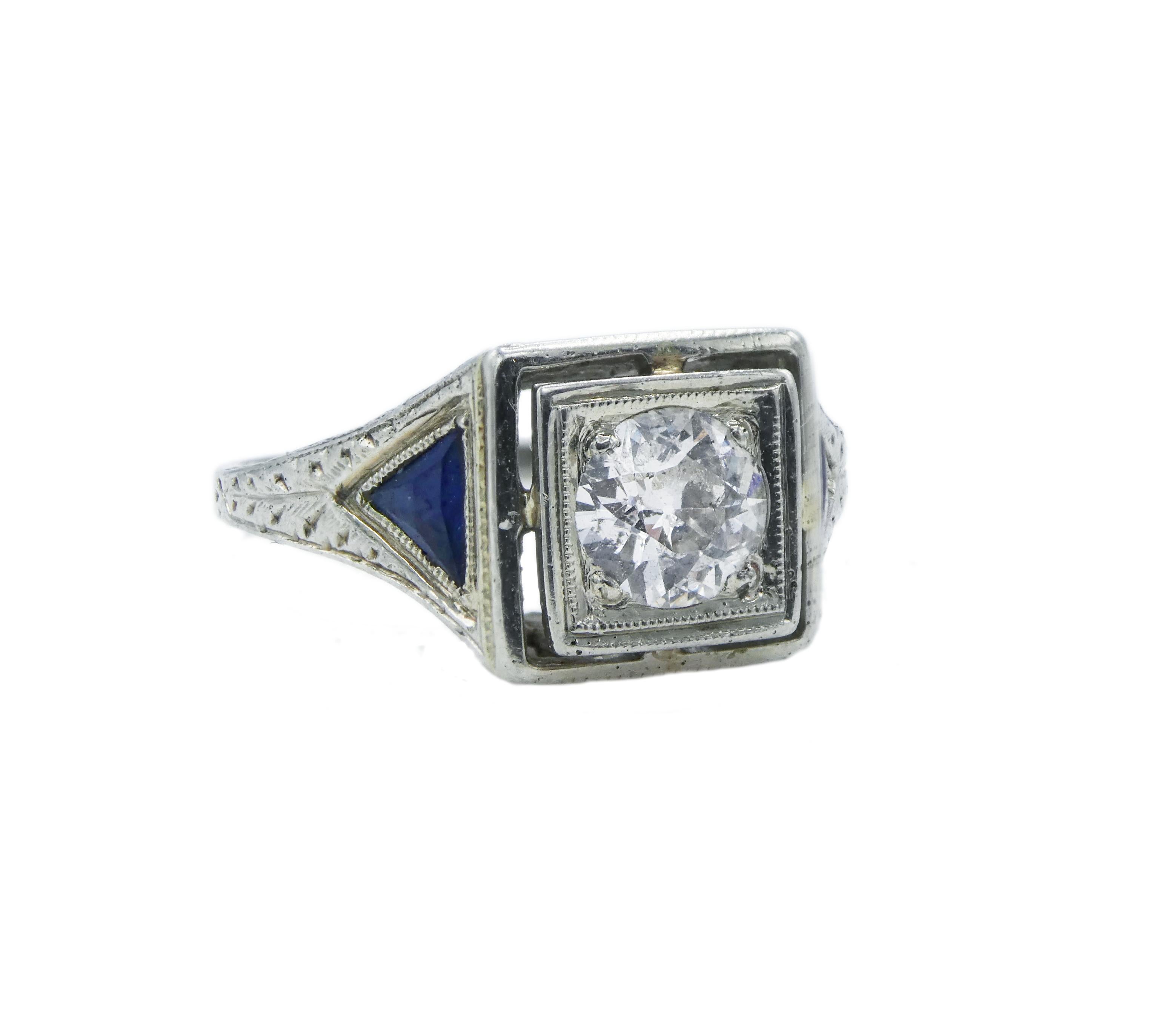 European Cut 0.35ct Diamond Sapphire 18 Karat White Gold Engagement Ring

Metal: 18k White Gold
Center Stone: Approx. 0.35ct European Cut Diamond G-H in color and I1/2 in clarity
Side Stones: two trillion blue sapphires measuring approx. 3.6mm x