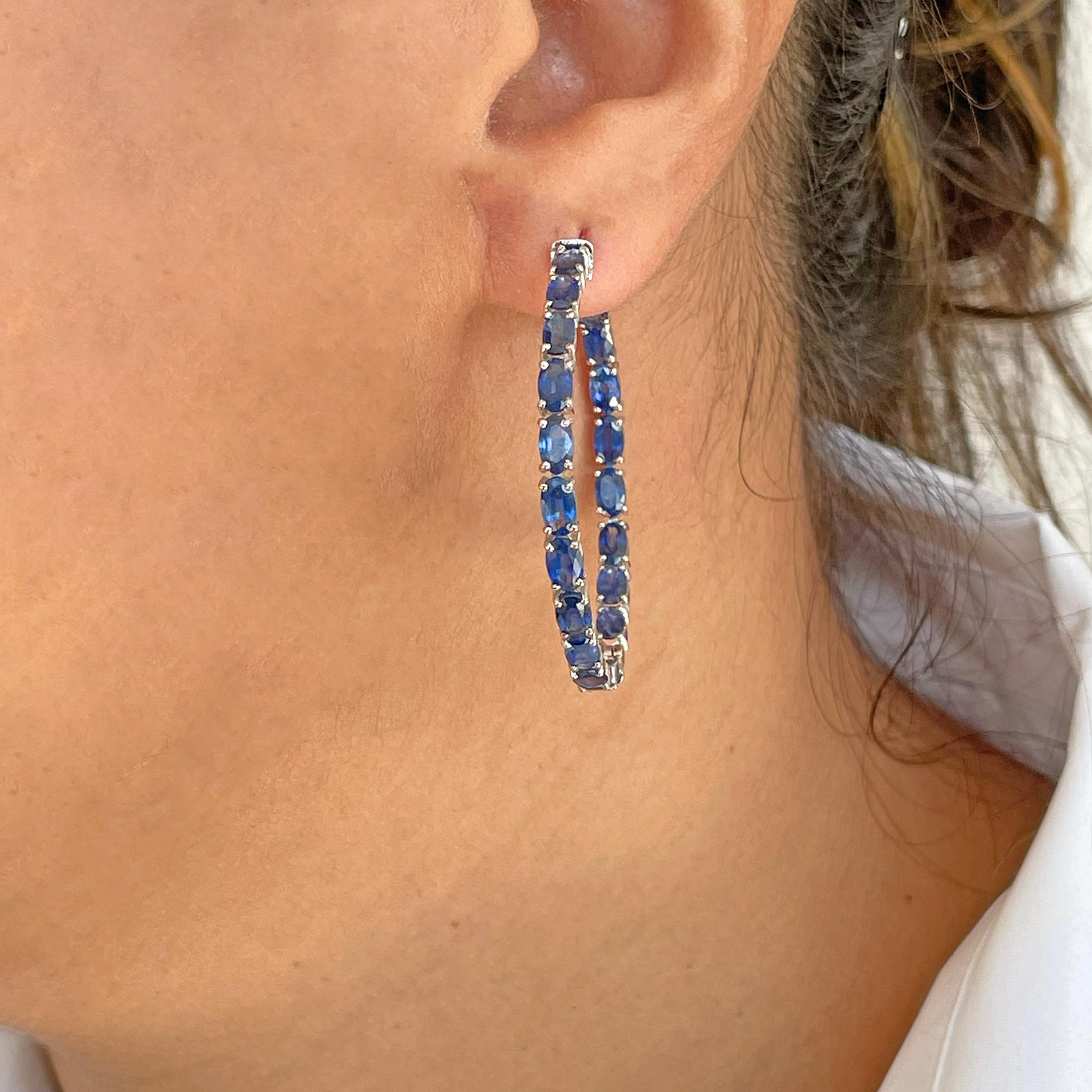 18 karat white gold 8.62 carats oval natural blue sapphire hoop earrings. 

This enchanting full hoop earrings featuring natural blue sapphires is impressive. The hoop is created with 40 perfect matching oval cut blue sapphires of size 5x3 mm each.