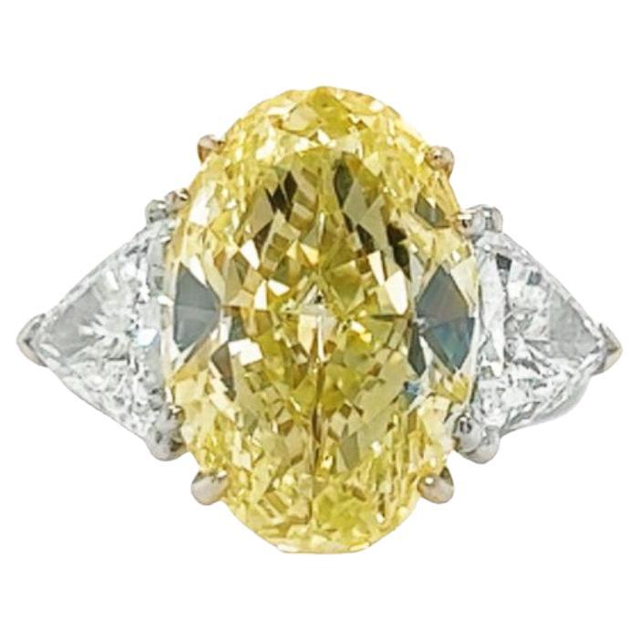 18K white gold diamond ring is from our Wedding Collection. This stunning piece of jewellery is made of a GIA certified oval cut 8.19 Carat diamond in fancy yellow colour, SI1 clarity and decorated with 2 trillion colourless diamonds in E colour and