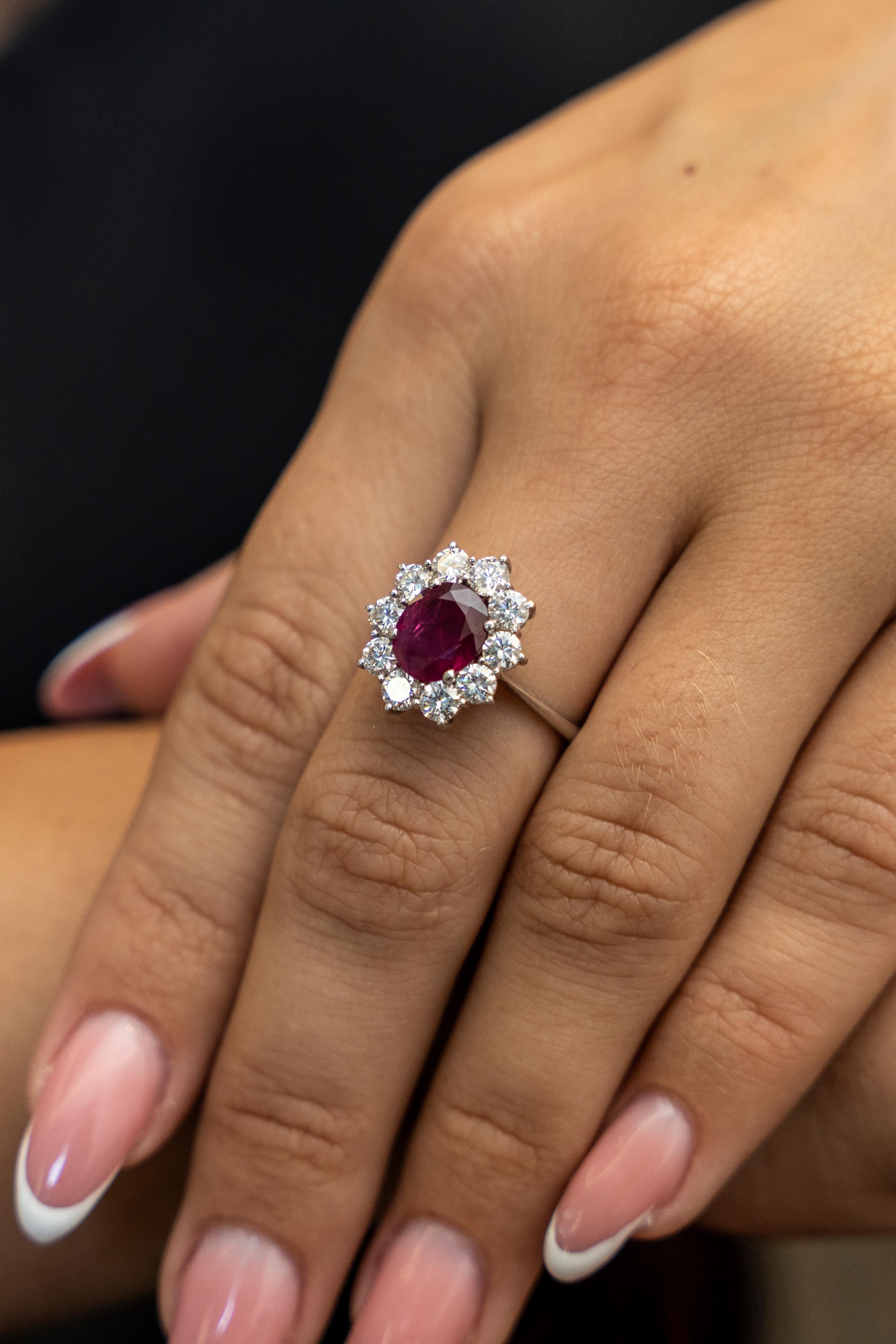 This 18K white gold stunning ring is from our Timeless Collection. It is made of a beautiful oval shape ruby in total of 1.94 Carat decorated by 10 colorless round shape diamonds in total of 1.24 Carat. Total metal weight is 3.66 gr.  Extraordinary