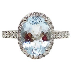 18 Karat White Gold Oval Shape Aquamarine and Diamond Halo Ring