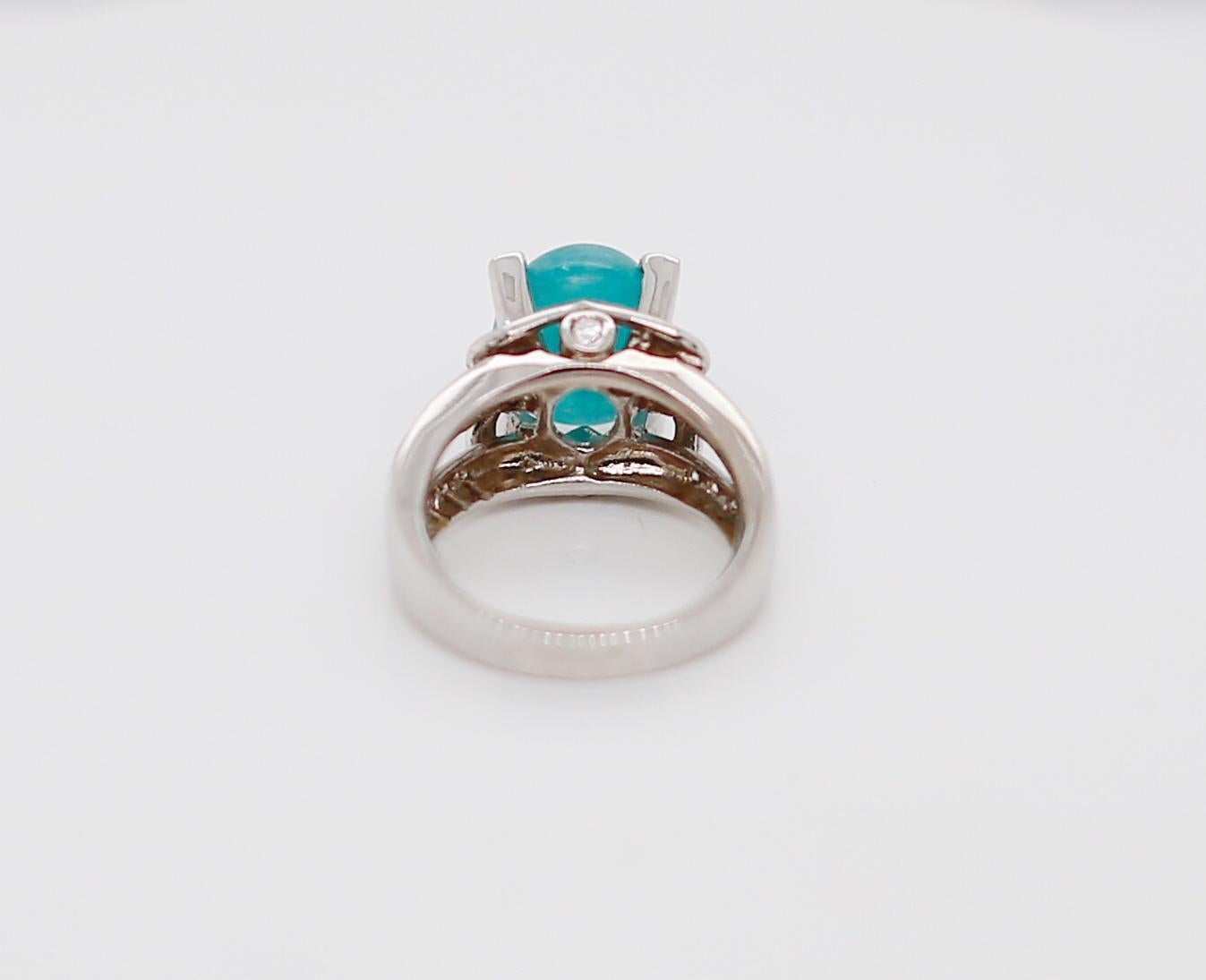 18 Karat White Gold Paraiba Tourmaline and Diamond Ring 
Paraiba Tourmaline Weight: 6.25ct 
Diamond Weight: 0.66twt 
Total Weight: 11.4g
Size: 6.5 (sizable) 
We offer Appraisals by The National Association of Jewelry Appraisals.
We guarantee all