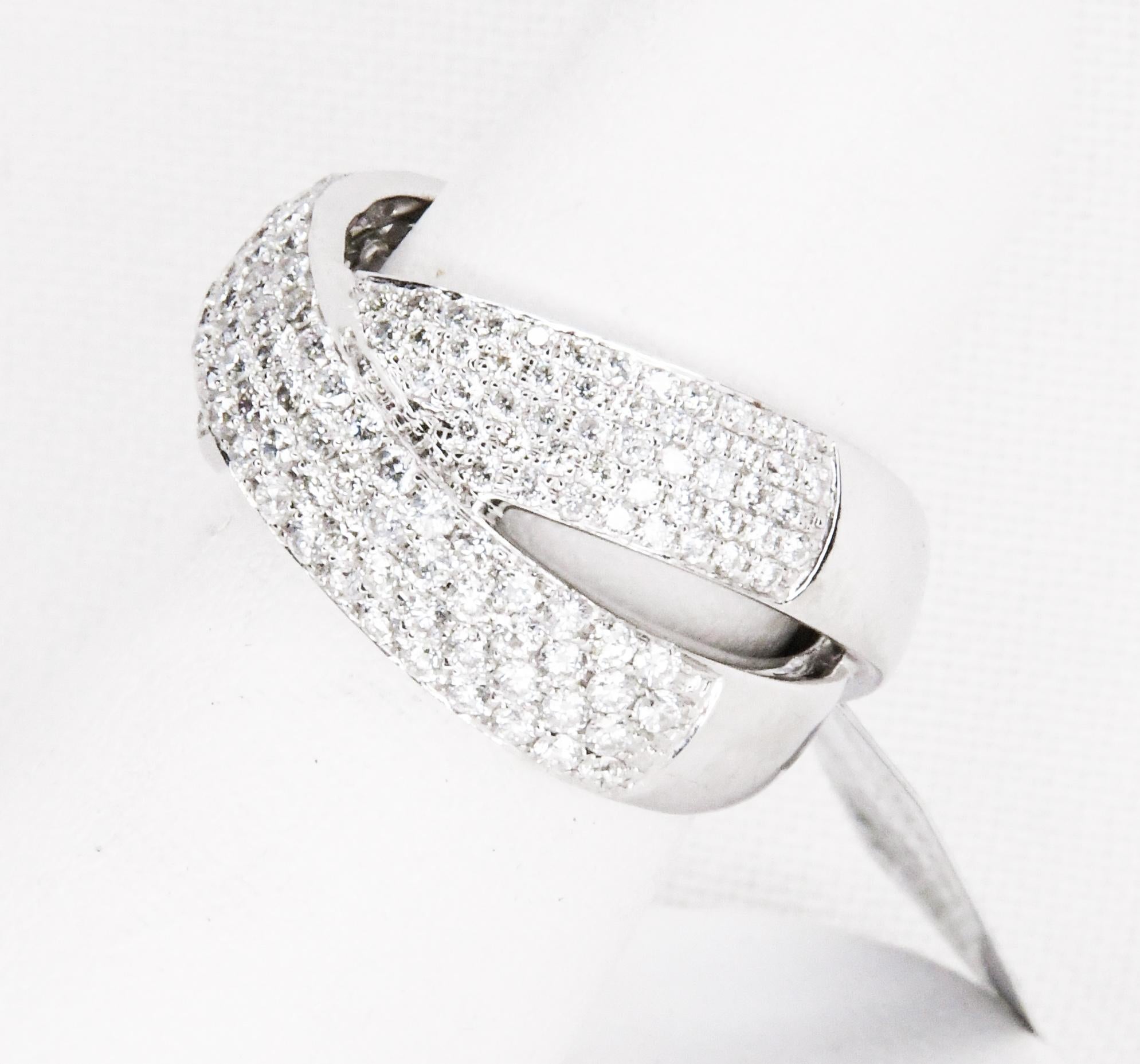 Meticulously crafted in 18 karat white gold, this crossover design band style ring is a sparkler!  197 beautifully matched brilliant cut pave set diamonds, weighing 2.00 carats with G-H color, VS Clarity.  A stunning wedding band or right hand