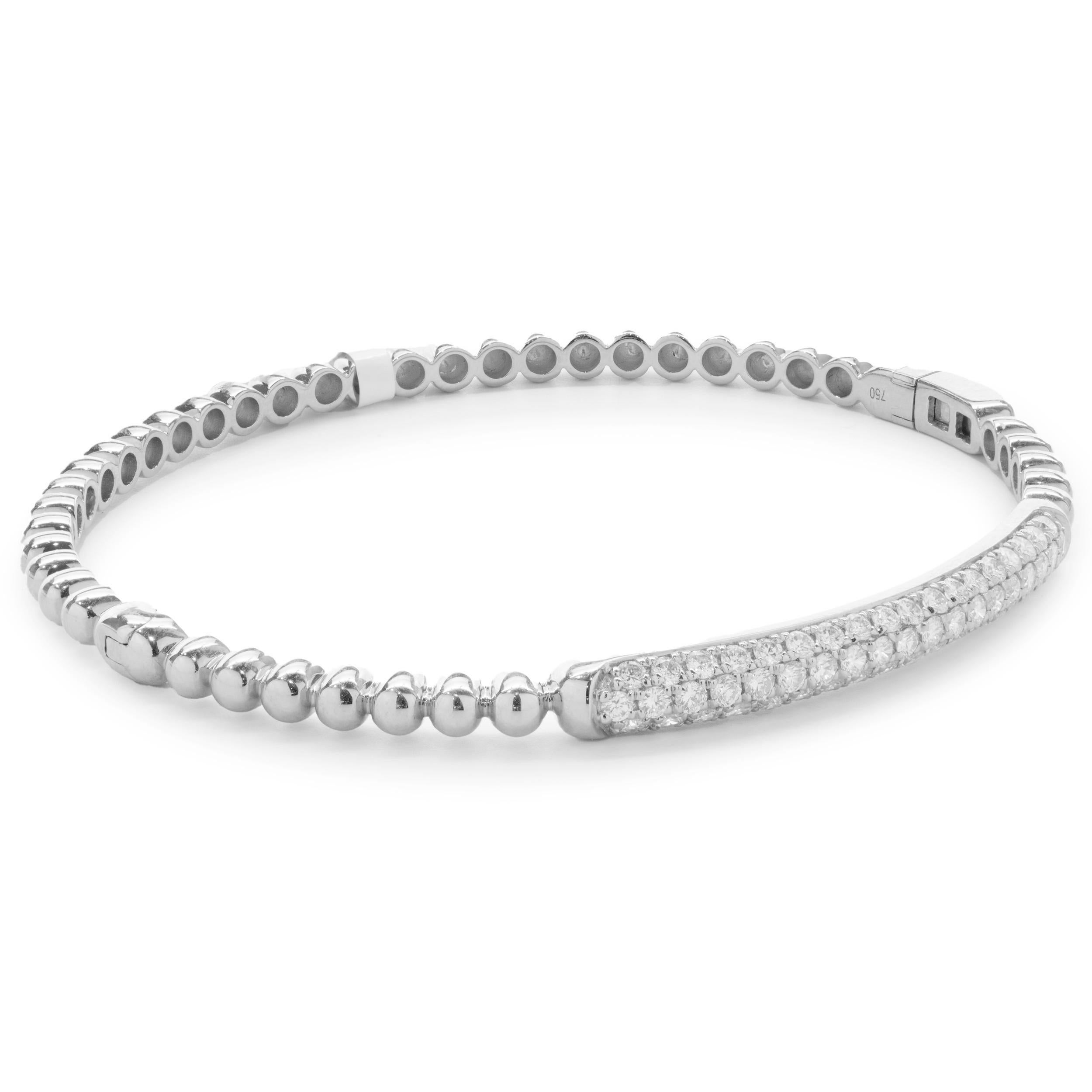 Designer: custom design
Material: 18K white gold
Diamonds: 55 round brilliant cut = 1.06cttw
Color: G 
Clarity: VS2
Dimensions: bracelet will fit up to a 7.5-inch wrist
Weight: 12.99 grams