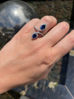 18 Karat White Gold Pear-Shaped Blue Sapphire Diamond Bypass Ring