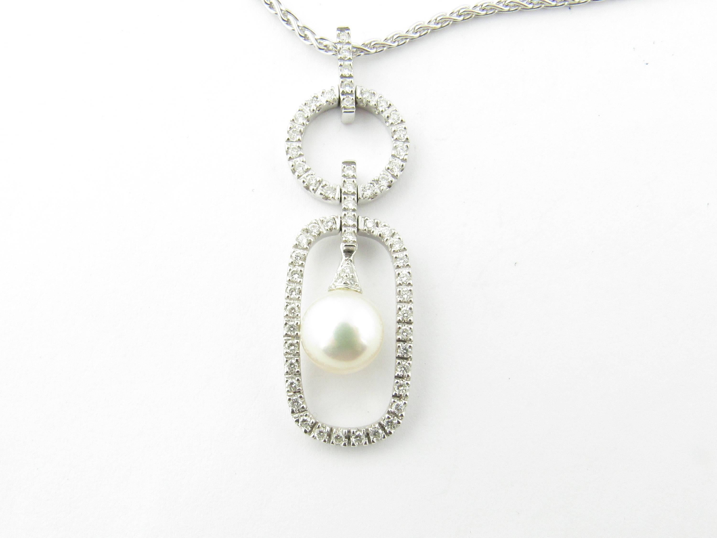 Vintage 18 Karat White Gold Pearl and Diamond Pendant Necklace-

This spectacular pendant features one dangling 9 mm pearl surrounded by 59 round brilliant cut diamonds. Suspended from a classic 18K white gold necklace.

Approximate total diamond
