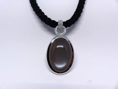 Pendant in White Gold with 1 black Moonstone and Diamonds.