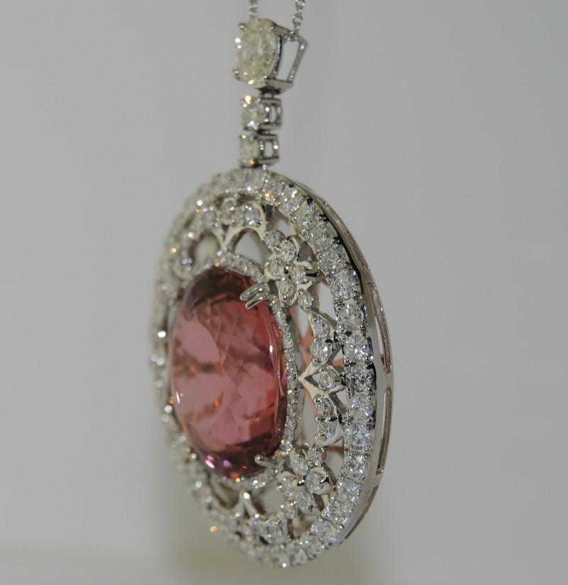 This 18-karat White Gold Pendant has a 28.62 carats Tourmaline set in the center and 
4.08 carats Round  Diamonds .
Length is 1.88 inches
