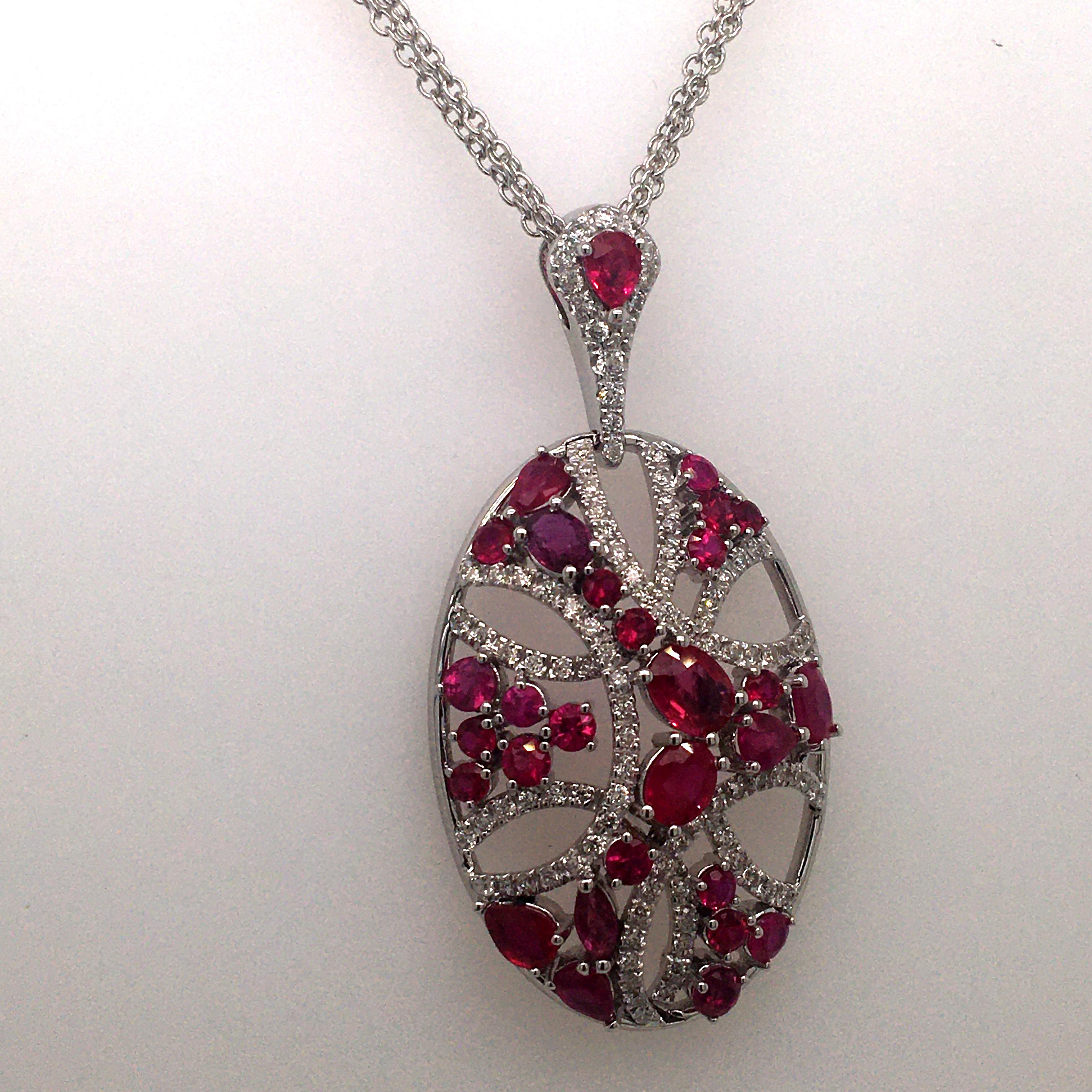 18 Karat white gold pendent set with 0.58 cts of Diamonds round cut Color G  clarity  VS  and 3.78 Cts of  multishape ruby, multichain  50 CM.
pendent only 4.2 CM, Made in Italy comes in a box,very nice movement given by the ruby stones, ruby are