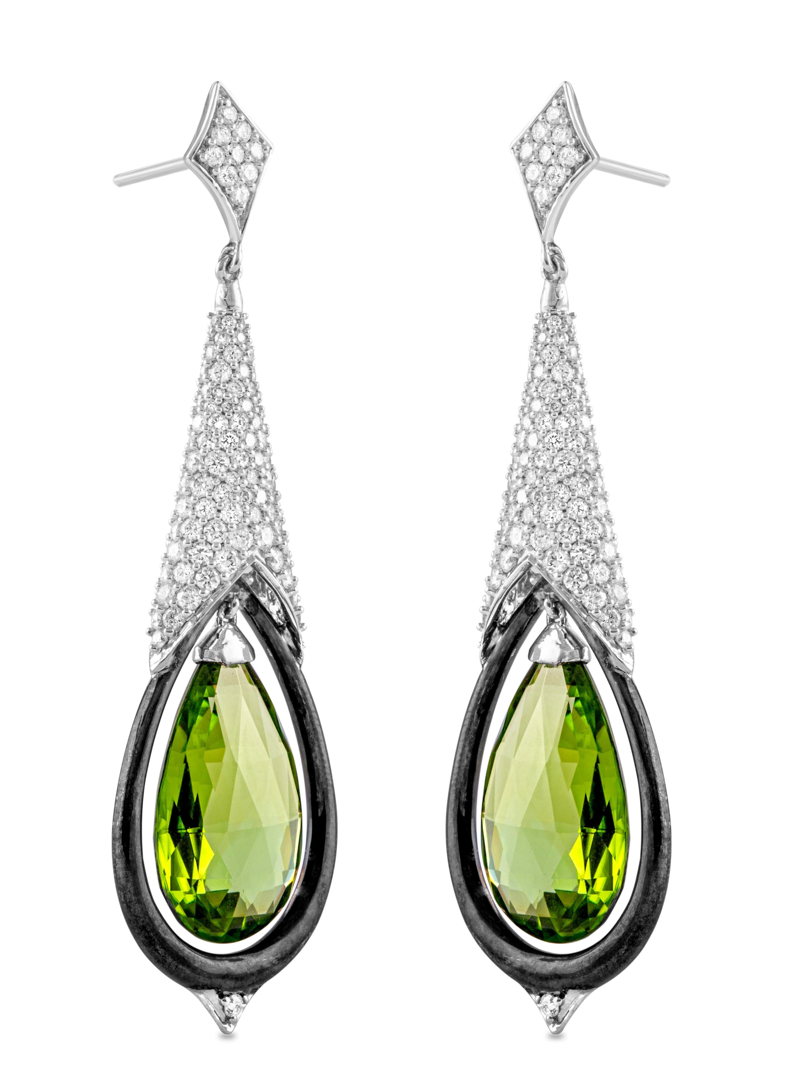 Peridot drops mysteriously float in these stunning diamond earrings in 18K white gold.

Given its colour and energetic properties, peridot is often considered a stone for opening the heart, as well as for attracting abundance, family harmony and