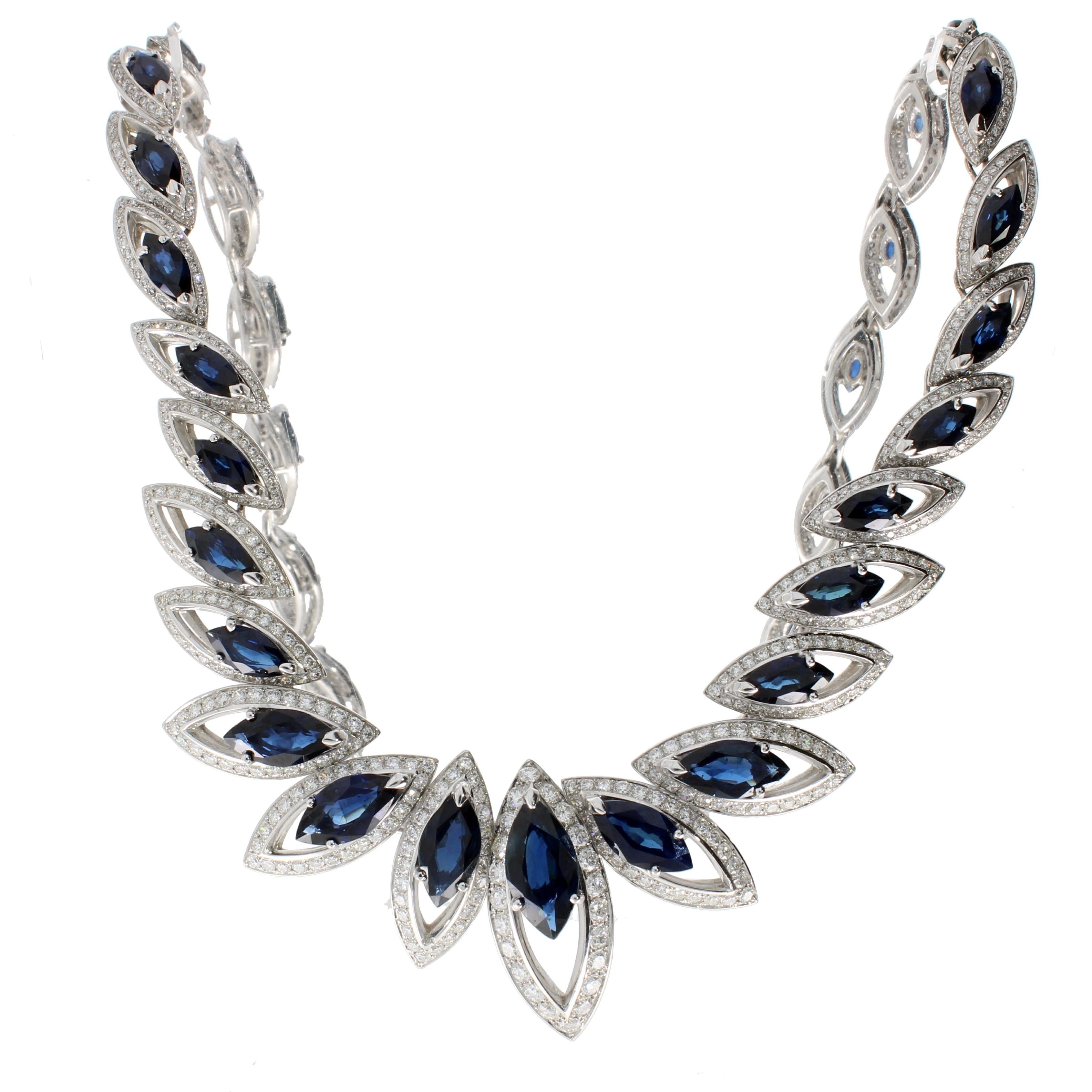 Tracing the delicate petals of a flower, signature marquise cut blue sapphires and brilliant cut diamonds form a sparkling garland around the neckline.

Details
Blue Sapphire and Diamonds Necklace
- 18 karat White Gold
- 23.8 carat Marquise Blue