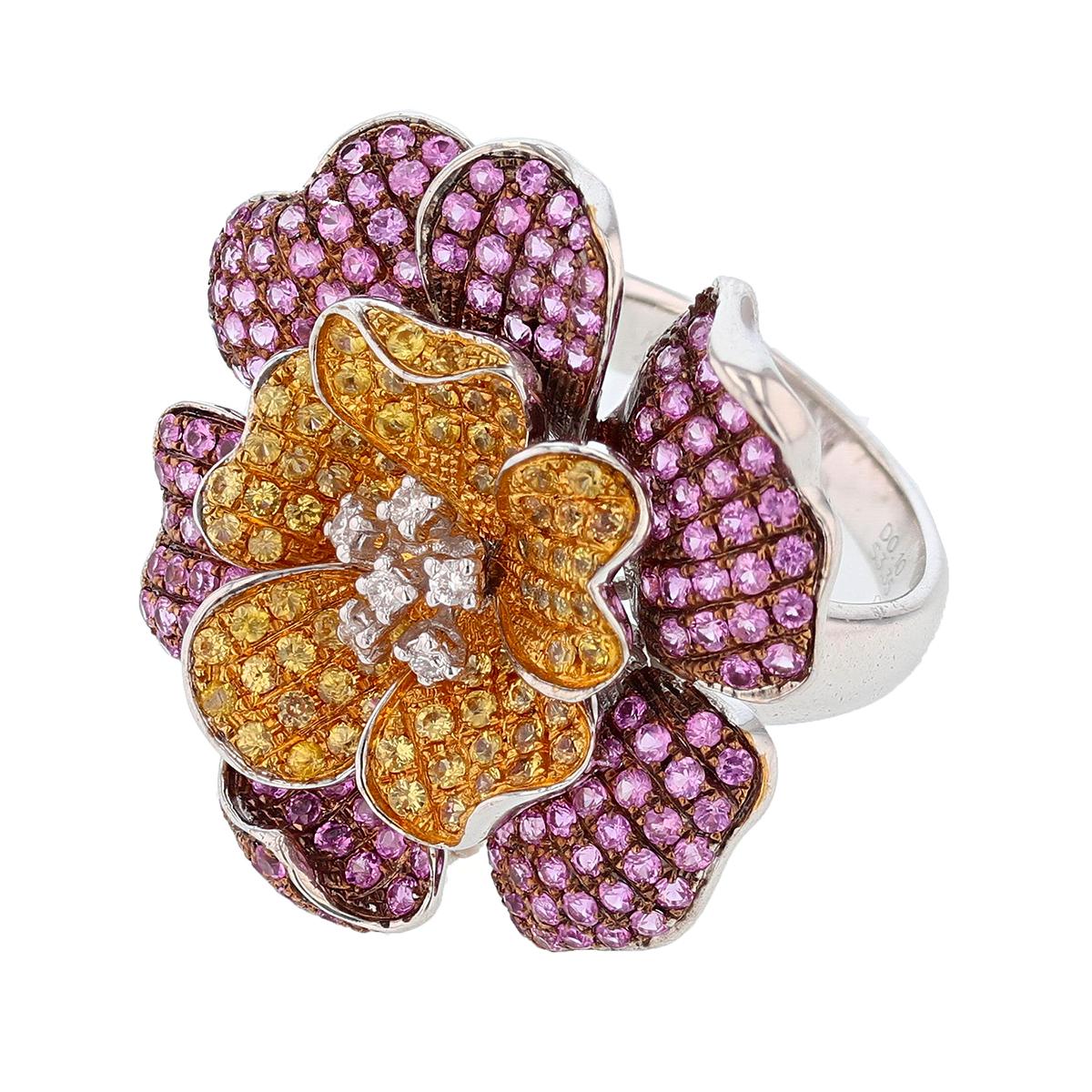 This ring is made in 18k white gold. The ring features 242 round brilliant cut Yellow Sapphire and Pink Sapphire weighing 3.30ct and 6 round cut diamonds weighing 0.10ct.