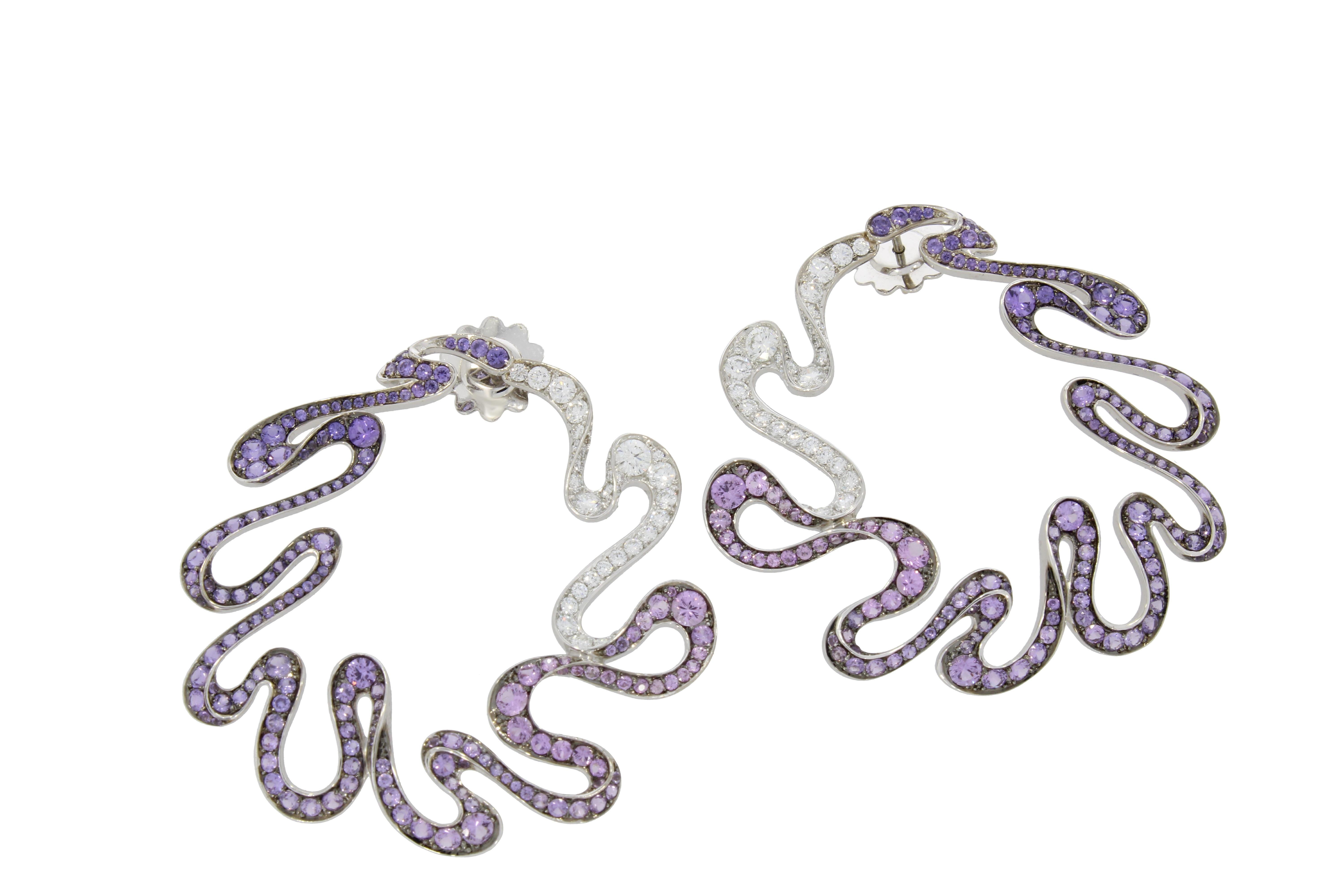 Rhythmic swirls of vivid Pink sapphires, amethysts and glistening diamonds, playfully encircle the ear capturing the graceful movement of a twirling ribbon.

Gold Pink Sapphires and Amethyst Danza Earring
- 18 karat White Gold
- 1.43 Carat White