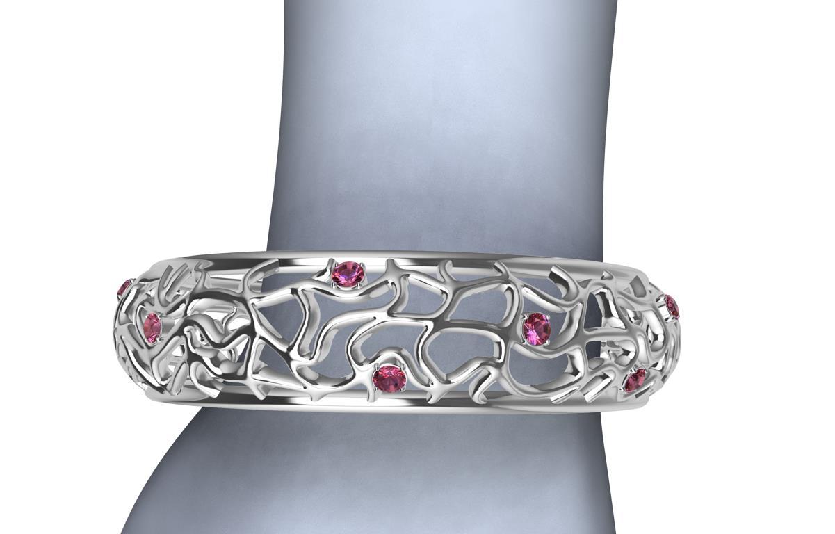 18 Karat White Gold Pink Sapphires Synergistic Bangle,   pink sapphires, 3.0 ct wt. What looks wild twisting, turning, and undulating, but held together with two rails. Accented throughout with pink sapphires popping adding more life into it. Made