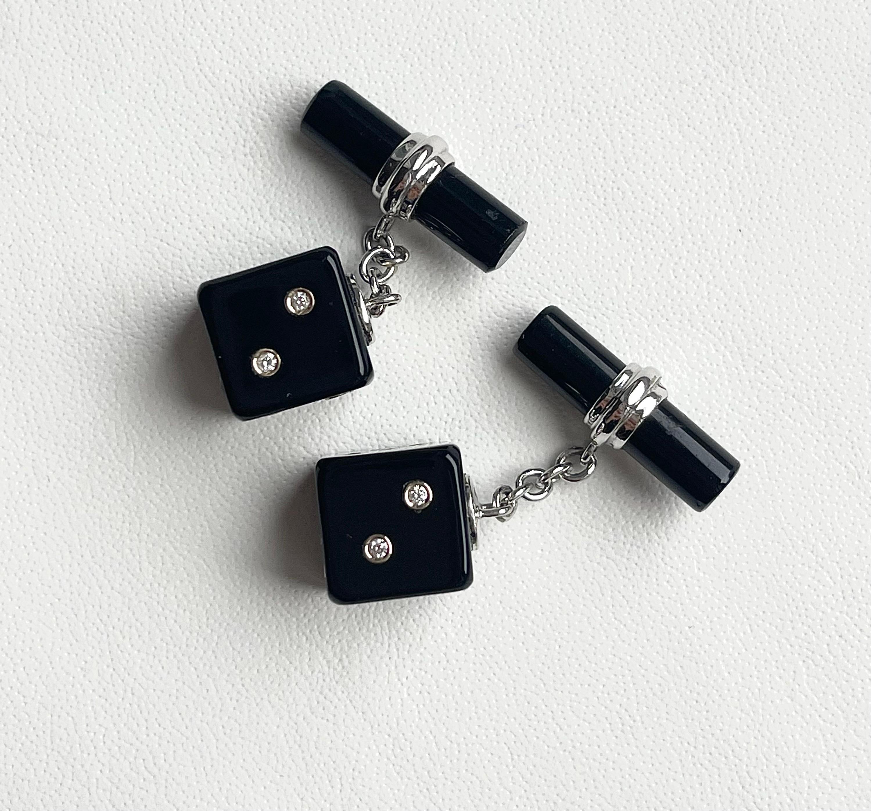 This sophisticated pair of cufflinks is entirely made of onyx and it features a simple, cylindrical toggle attached to the front with an 18k white gold post.        
The front face is shaped as a cube with its striking black surface highlighted by