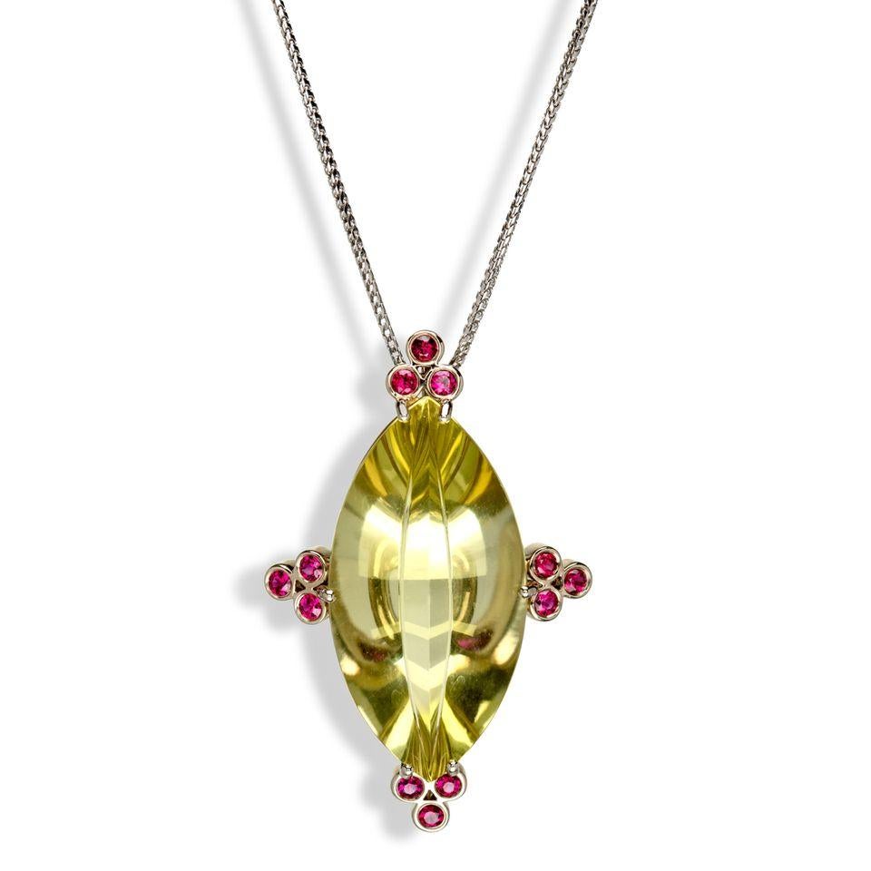 The star of this pendant is the large, special cut “navette” prasiolite, which is further enhanced by a trio of rubies set in 18k white gold at each of the four cardinal points for a polished framed look. A real gem of a pendant not to be
