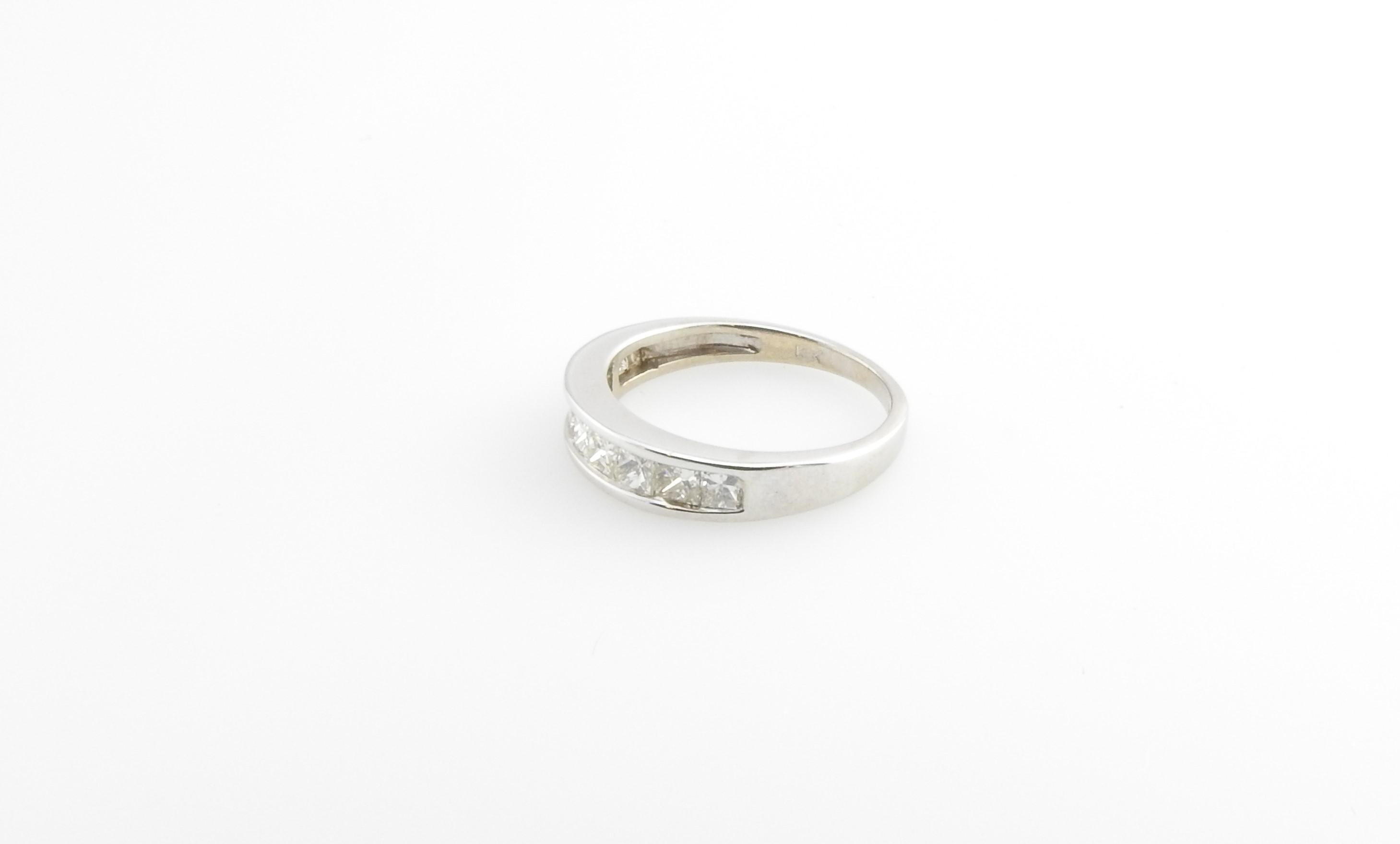 This sparkling wedding band features nine princess cut diamonds set in elegant 18K white gold.

Width: 4 mm. Shank: 2 mm.

Approximate total diamond weight: .70 ct.

Diamond color: J-K

Diamond clarity: I1-S1

Ring Size: 5.25

Weight: 1.7 dwt. / 2.7