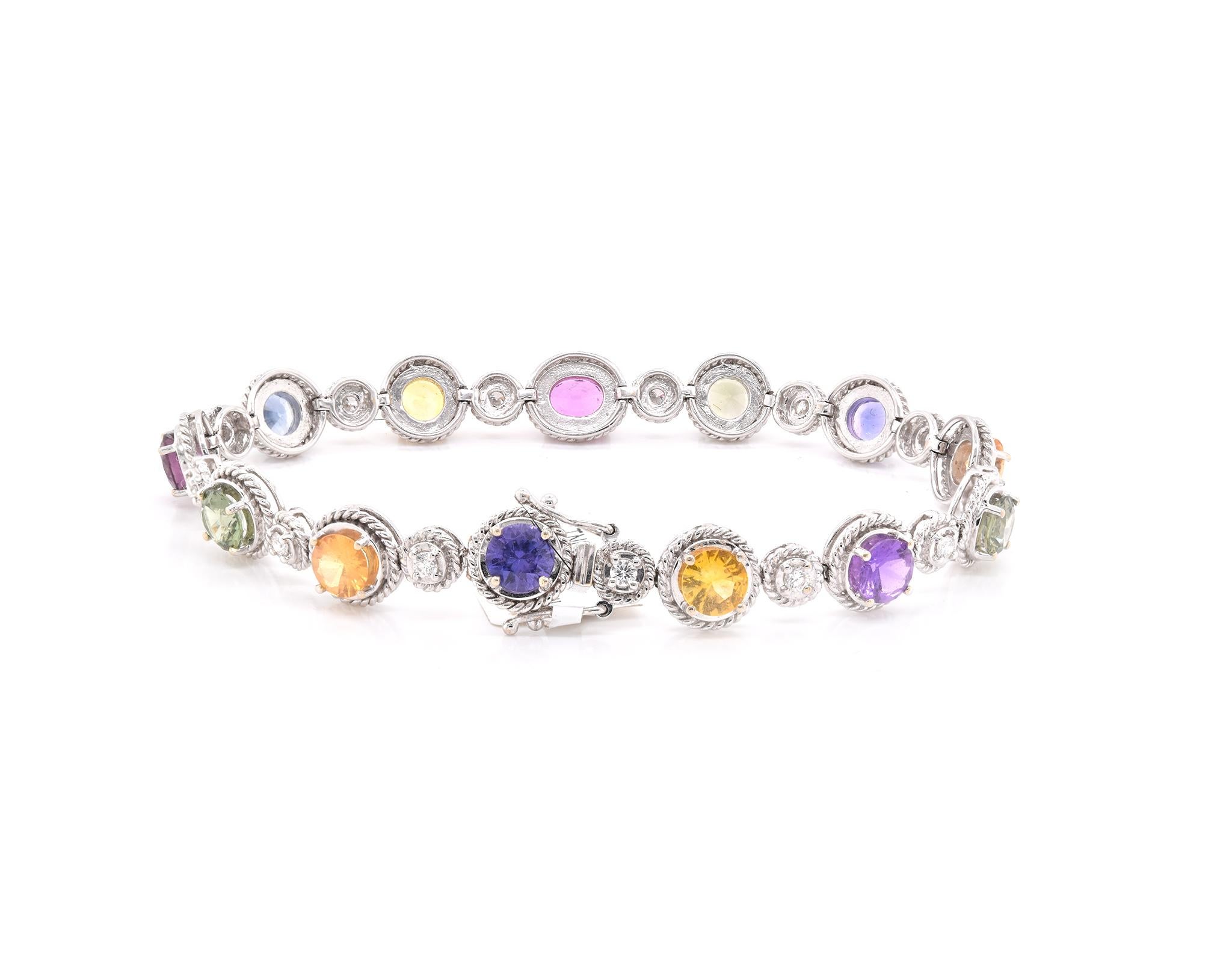 Designer: custom
Material: 18K white gold
Diamond: 13 round brilliant cut = 0.55cttw
Color: G
Clarity: SI
Sapphire: 9.39cttw Rainbow
Weight:  21.18 grams
Dimensions: bracelet measures 7.25-inches
