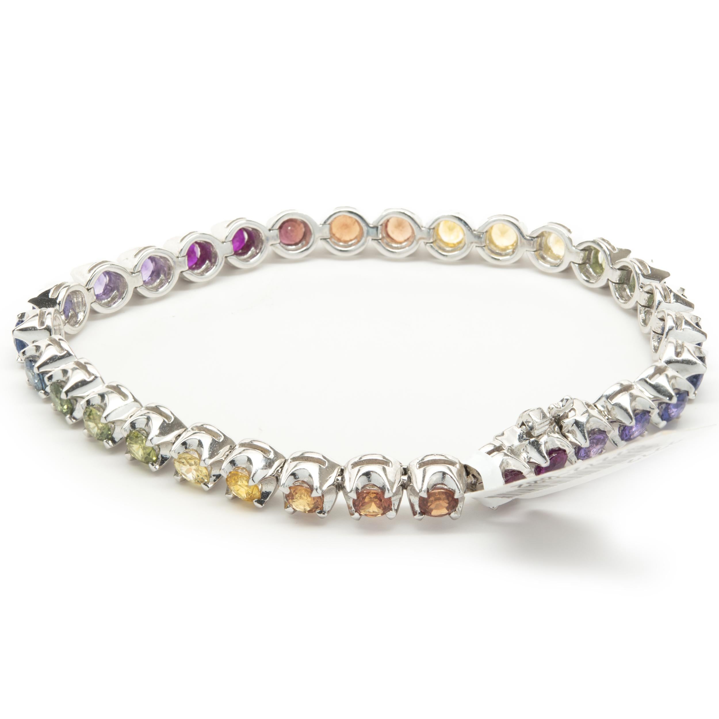 Designer: custom
Material: 18K white gold
Sapphire: 31 round brilliant cut = 9.18cttw
Color: Rainbow
Clarity: AAA+
Dimensions: bracelet will fit up to a 7-inch wrist
Weight: 24.95 grams