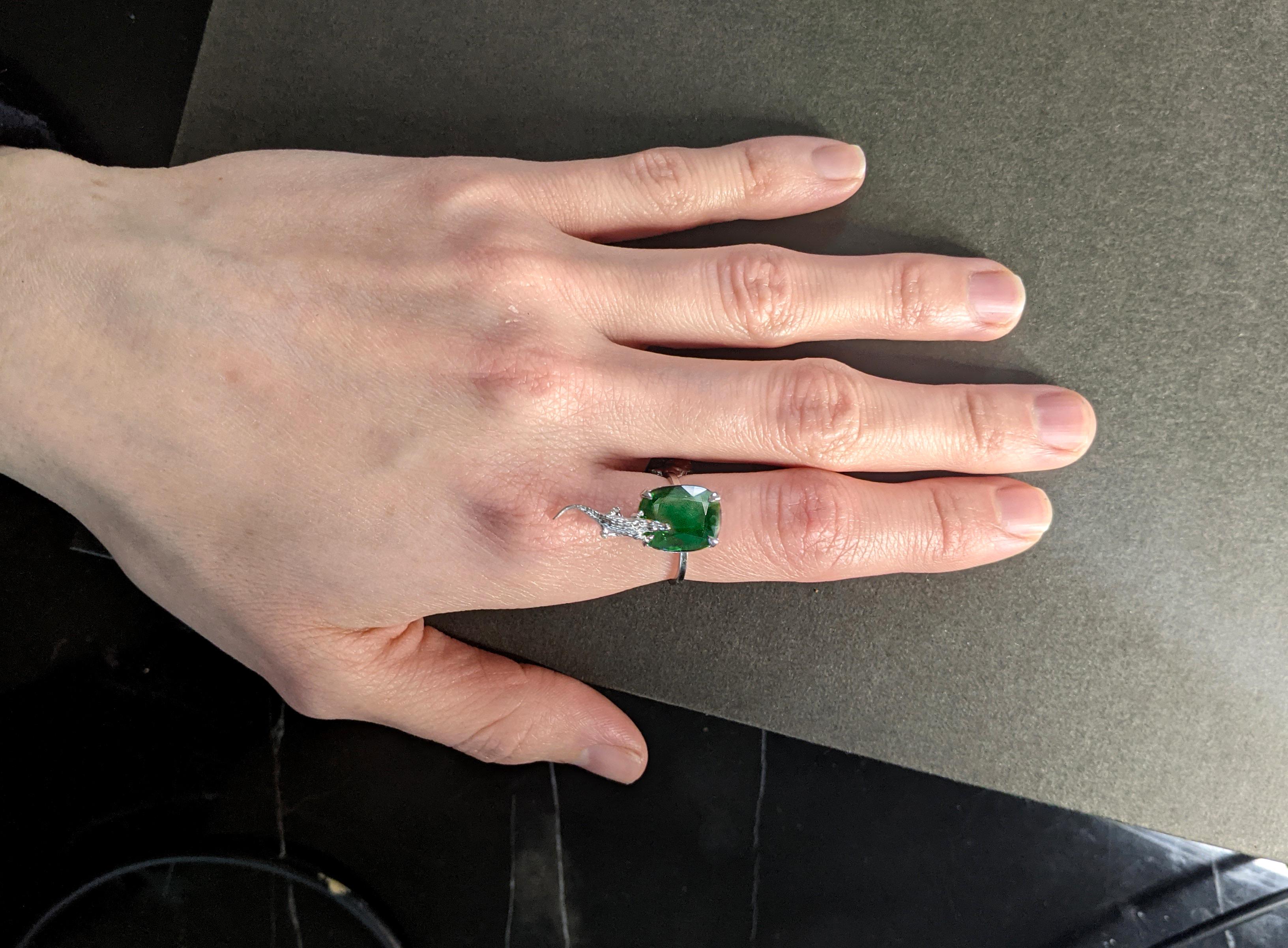 This 18 karat white gold contemporary Mesopotamian designer ring is encrusted with a stunning 2.23 carat natural cushion emerald, measuring 11x8.7 mm. The gem's neon green color is truly captivating and enhances the ring's modern design.

You can