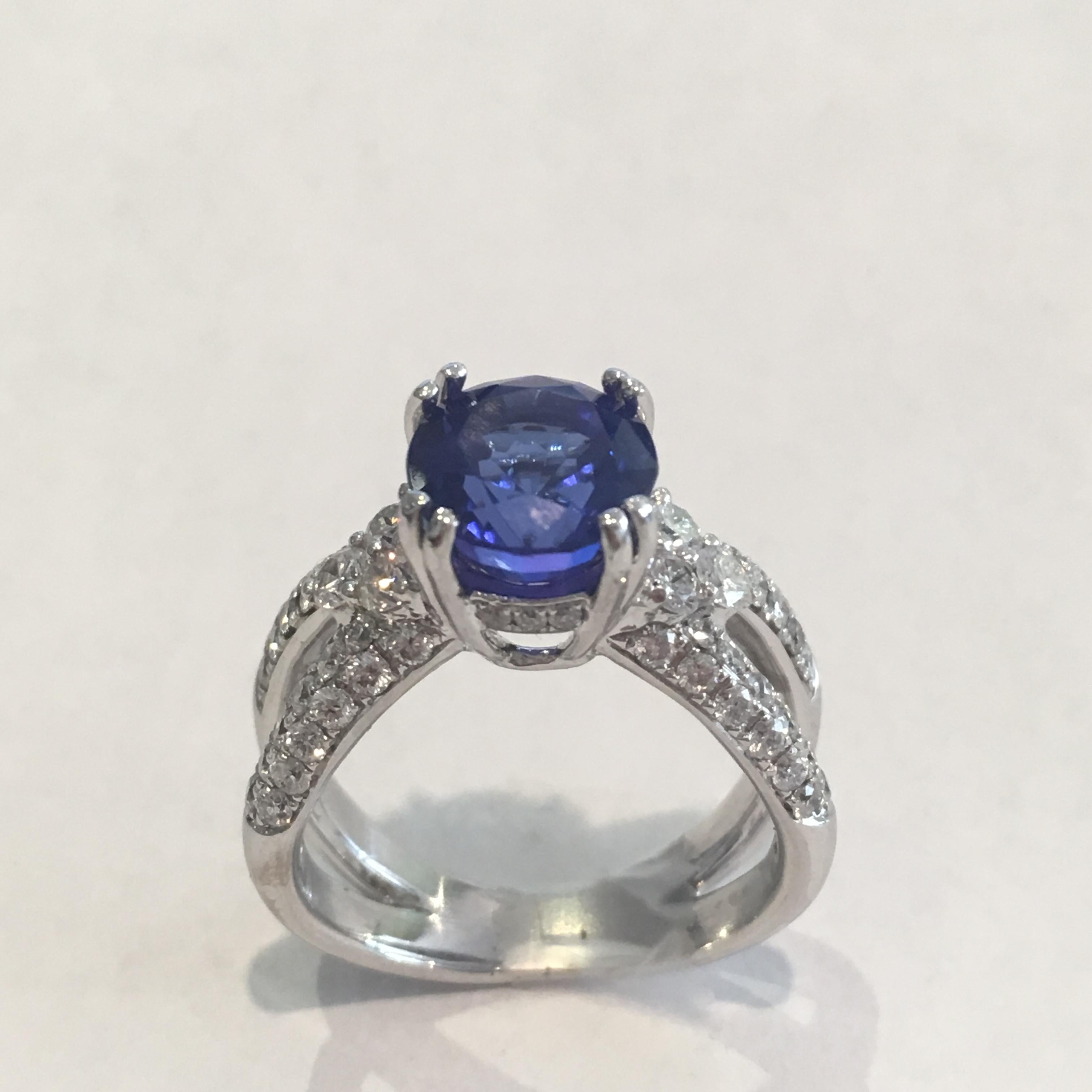 Ladies Custom Tanzanite And Diamond Ring In 18k White Gold.
Tests 18k And Weighs 9.4 Grams.
The Center Stone Is A 3.30 Carat Round Brilliant Cut Tanzanite, Deep, Bluish-Violet Color.
The Tanzanite Is Set In A 4 , Double Prong Setting.
The Mounting