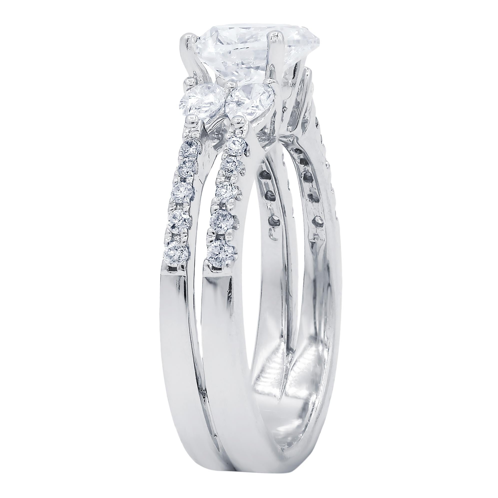 18 karat white gold heart cut diamond ring,weighing 1.01 carat and set with pear and round cut diamonds on the side with total weight 1.00 carat 
