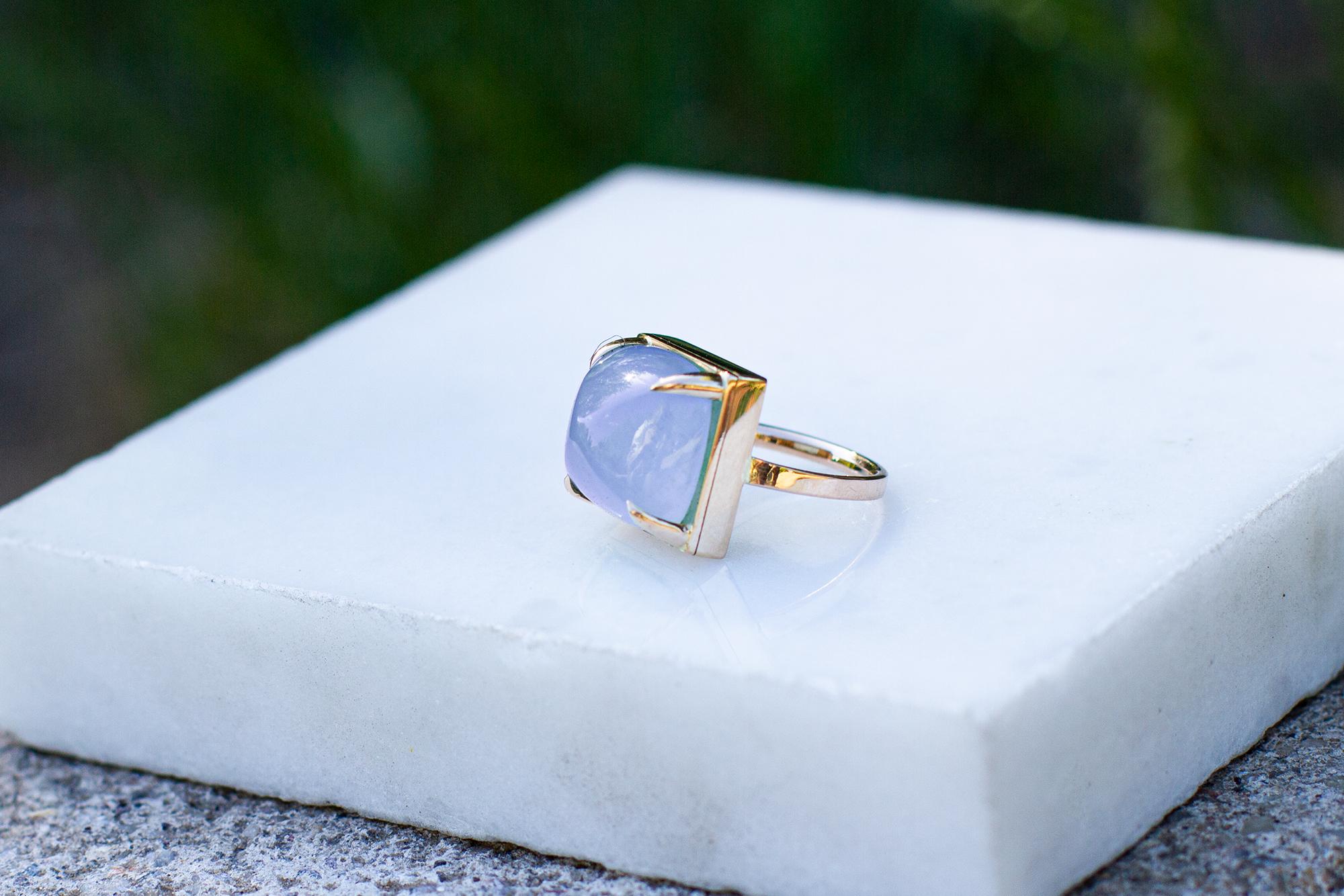 This contemporary cocktail ring is made of 18 karat white gold and sugarloaf cut chalcedony. This ring can be personally signed. 
When for most of the gem it works the way: the smaller prongs the better. This is the shape and size of the gem that we