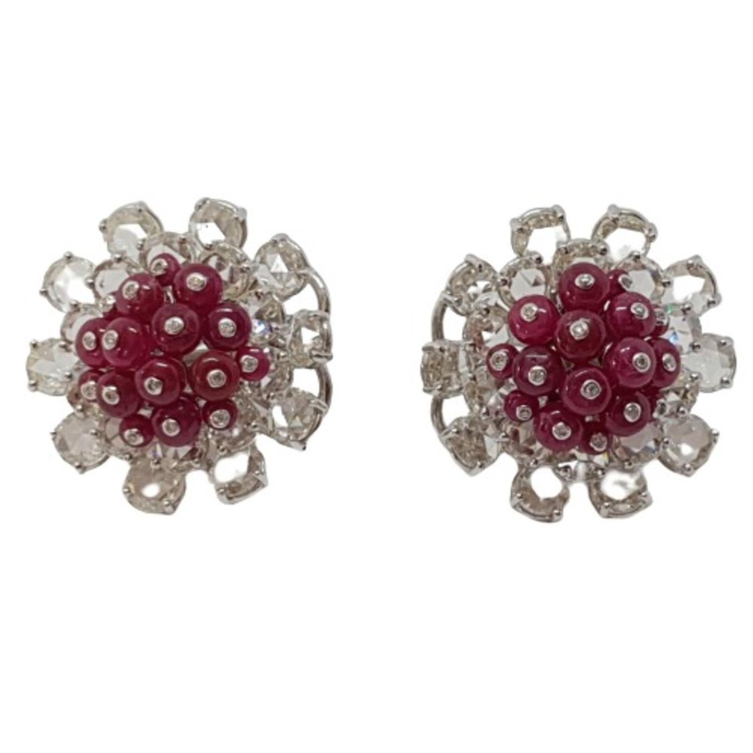 Prong set round rose cuts are placed in layers & the natural Burmese ruby beads form a dome to give these earrings a definition. These modern ear studs are crafted with minimum metal & the setting of the rose cuts is done in a way that the