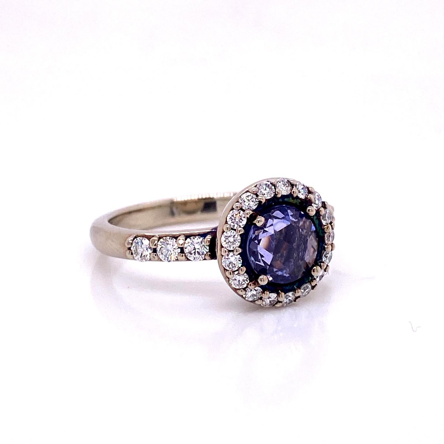An 18k white gold ring set with a .88ct  rose cut purple sapphire with a halo of round full cut diamonds G to H color and VS clarity .42 carats. Ring size 6.5. This ring was made and designed and made by llyn strong.