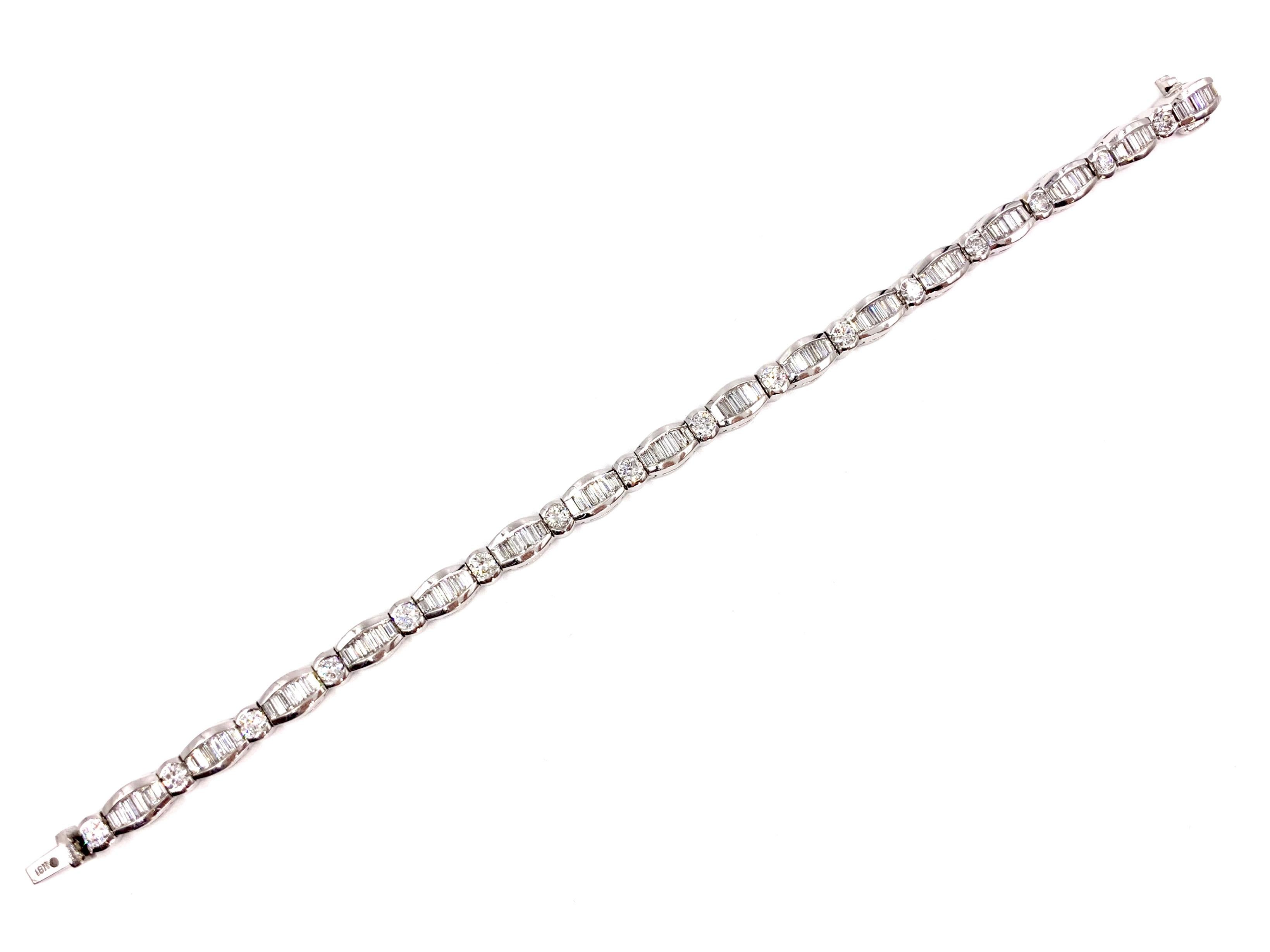 Gorgeous contemporary 18 karat white gold tennis bracelet featuring 16 round brilliant and 96 baguette diamonds at 5.25 carats total weight. Diamonds are of exceptional quality at approximately E-F color, VS2 clarity and are beautifully channel set