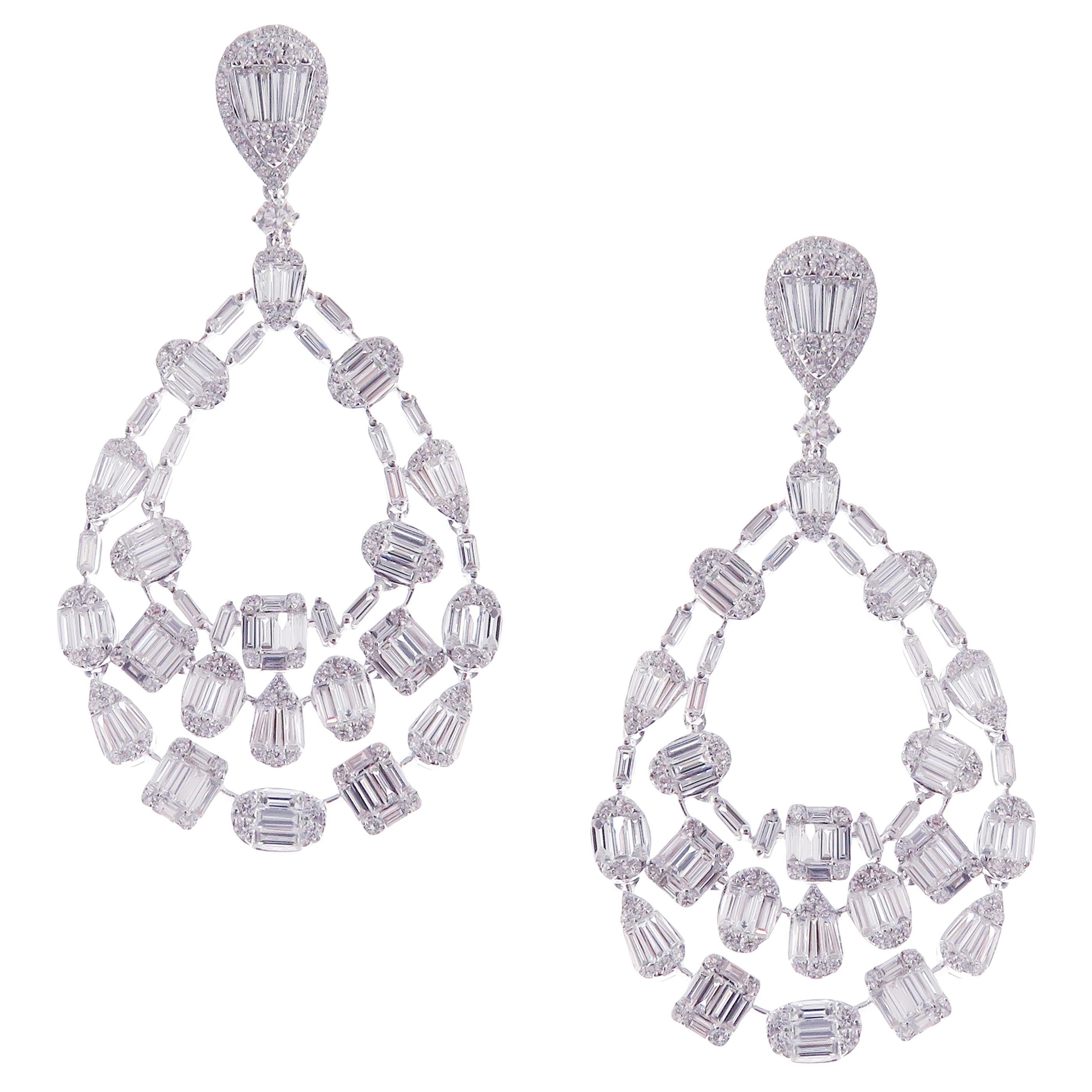 These elegant multi shapes dangling earrings with illusion setting round and baguette white diamonds are crafted in 18-karat white gold, featuring 250 round white diamonds totaling of 2.59 carats and 190 baguette white diamonds totaling of 6.43