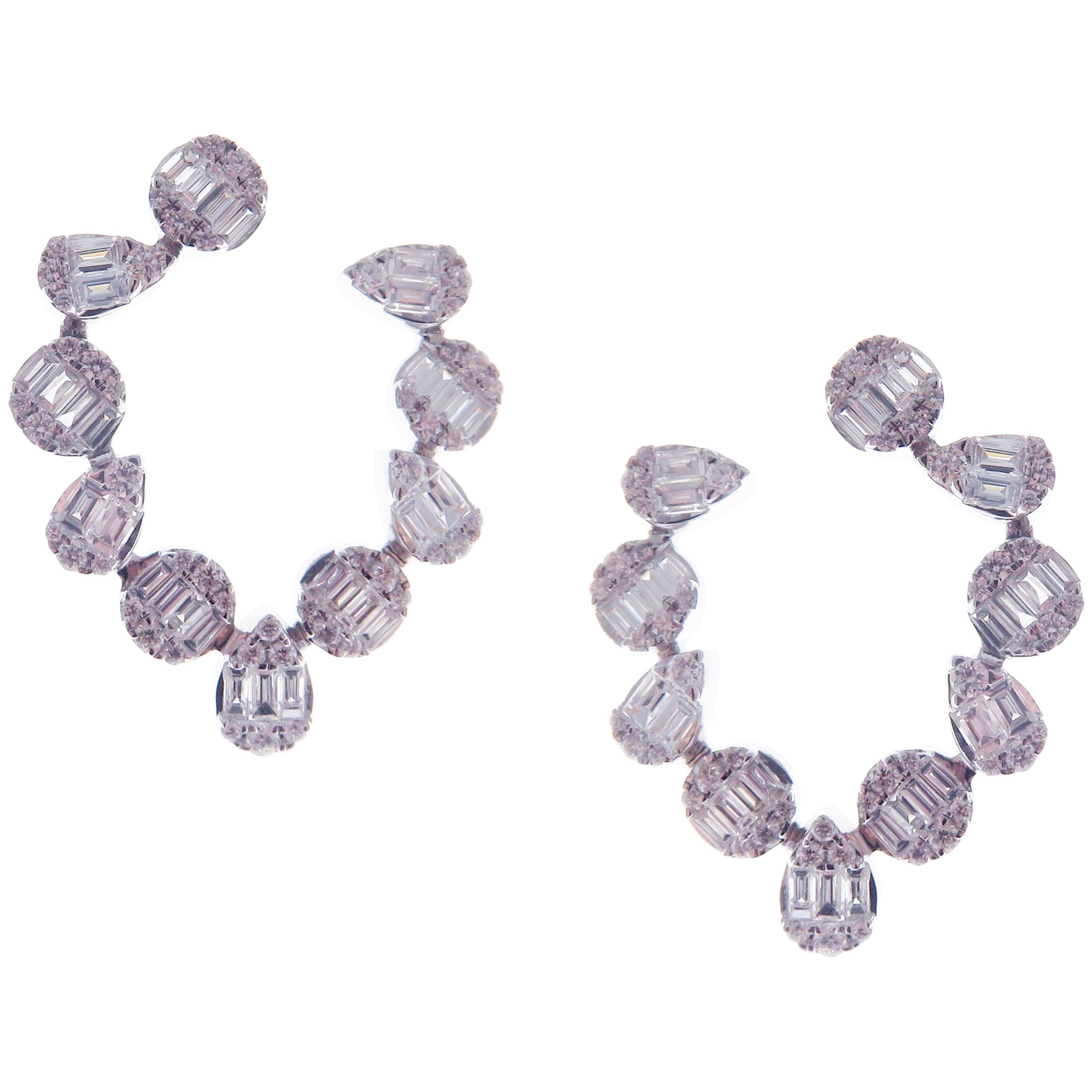 These trendy multi shapes twisty earrings with illusion setting round and baguette white diamonds are crafted in 18-karat white gold, featuring 84 round white diamonds totaling of 0.68 carats and 62 baguette white diamonds totaling of 1.39