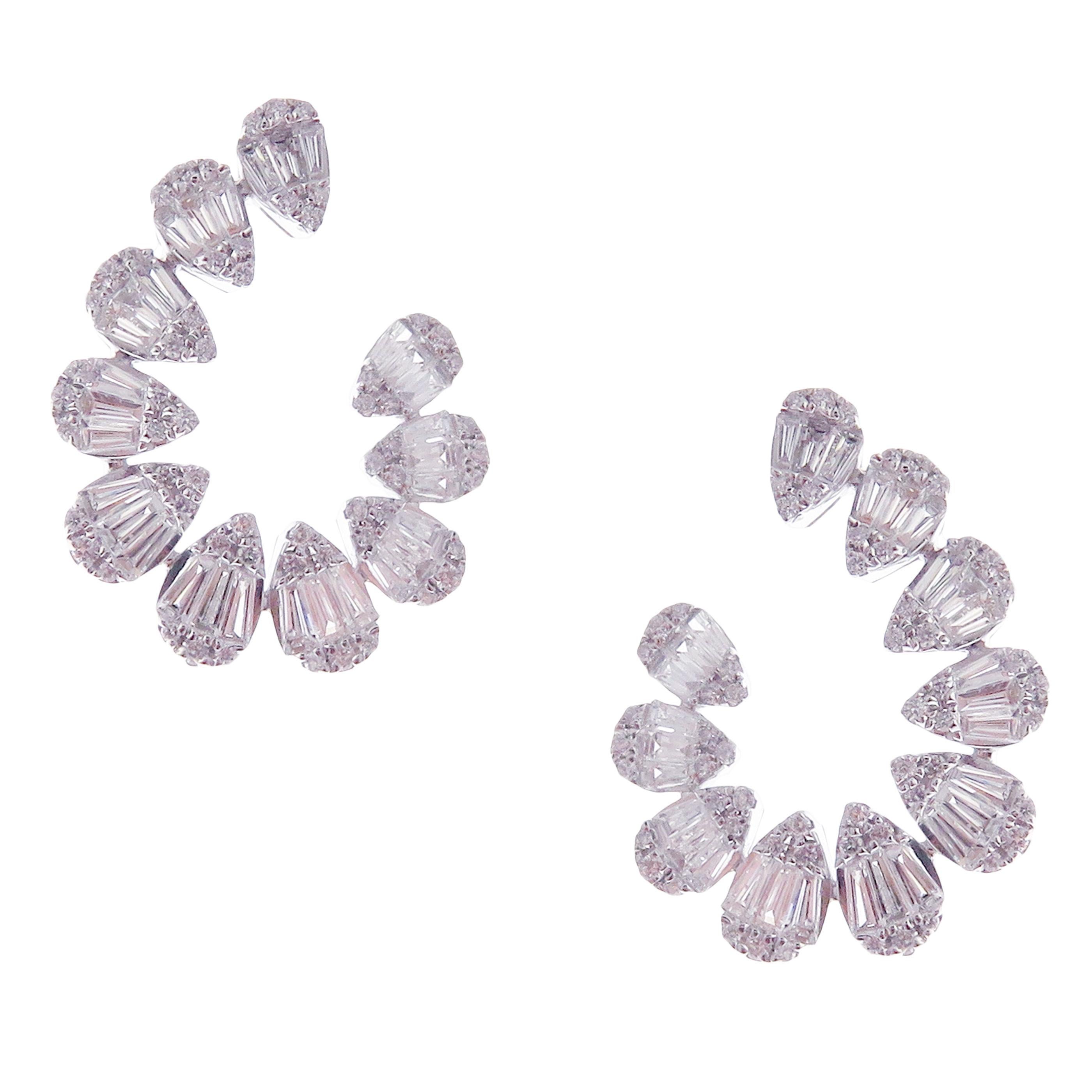 These trendy teardrop-shaped twisty earrings with round and baguette white diamonds are crafted in 18-karat white gold, featuring 120 round white diamonds totaling of 0.45 carats and 60 baguette white diamonds totaling of 1.17 carats.
These earrings
