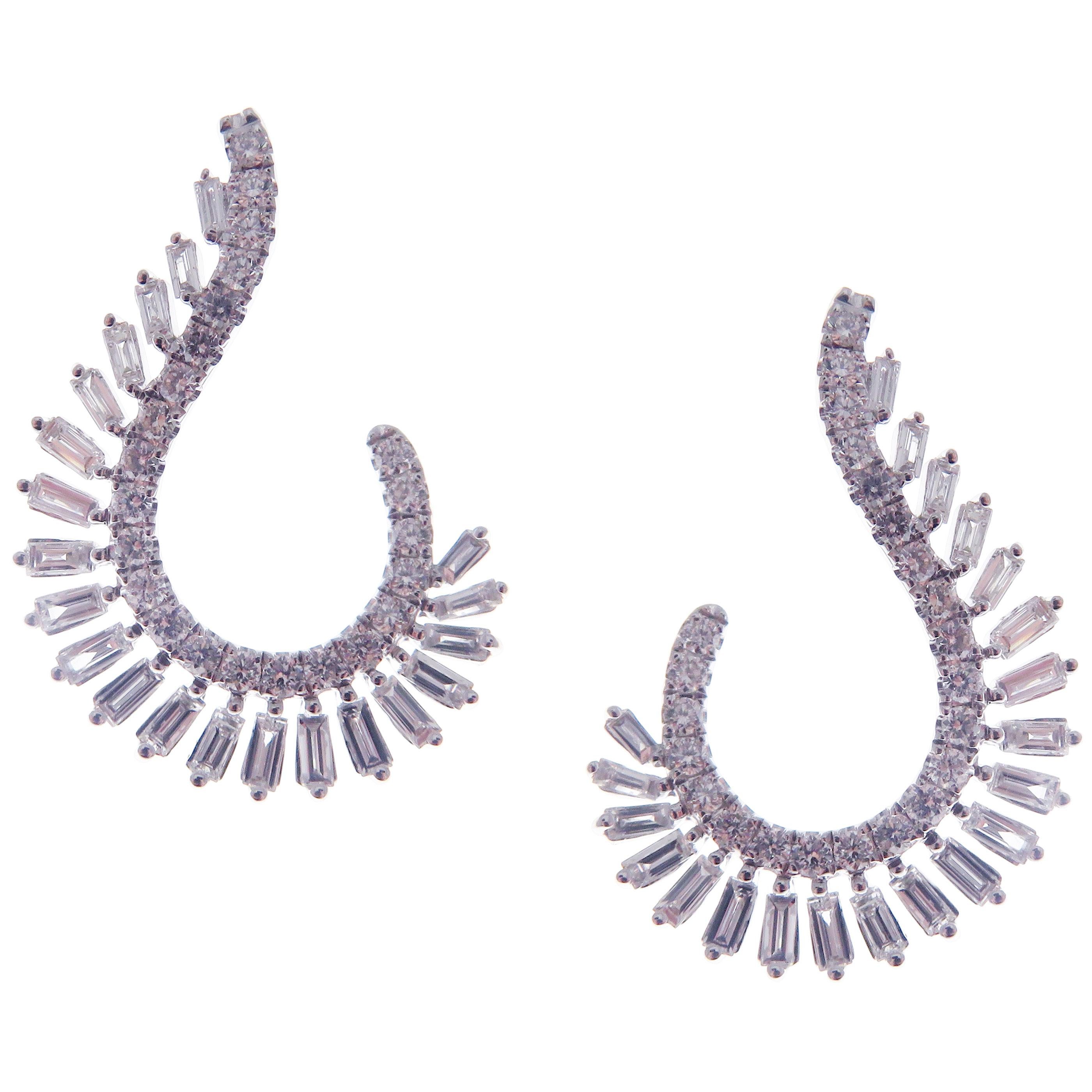 These trendy twisty wings earrings with round and baguette white diamonds are crafted in 18-karat white gold, featuring 48 round white diamonds totaling of 0.51 carats and 42 baguette white diamonds totaling of 0.88 carats.
These earrings come with