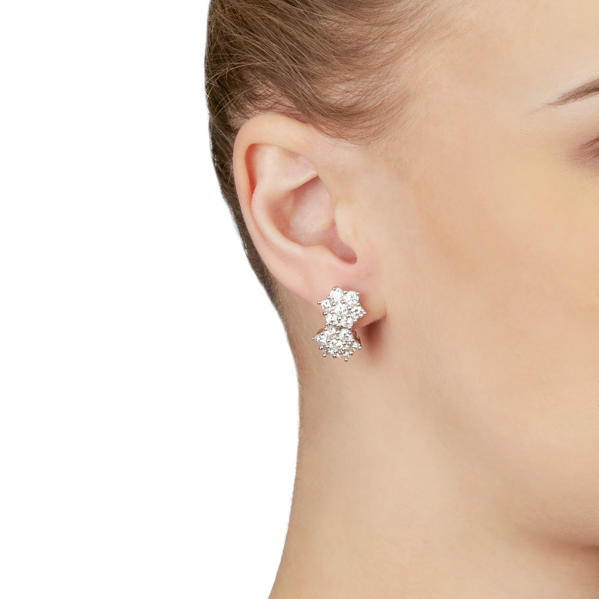 These Earrings feature a double cluster of 28 round brilliant cut Diamonds of 2.75ct total colour G, clarity VS, made in 18k White Gold. These Earrings are suitable for pierced ears and have omega backs. Complete with Xupes Presentation Box. 
