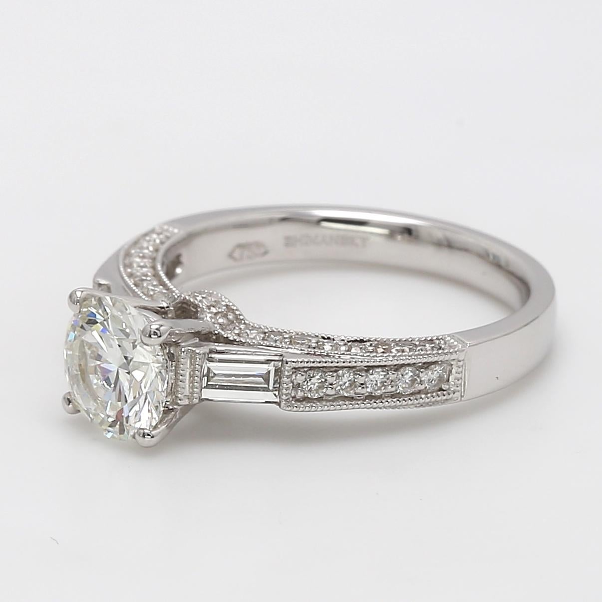 Stunning handcrafted 18 Karat White Gold Engagement Ring.
Round Brilliant Cut White diamond 1.1078 ct  I color and VS1 clarity, flanked by Baguette cut diamonds totaling 0.27ct G-H color and VVS1-VVS2 clarity and Round Brilliant Cut 0.36 ct G-H