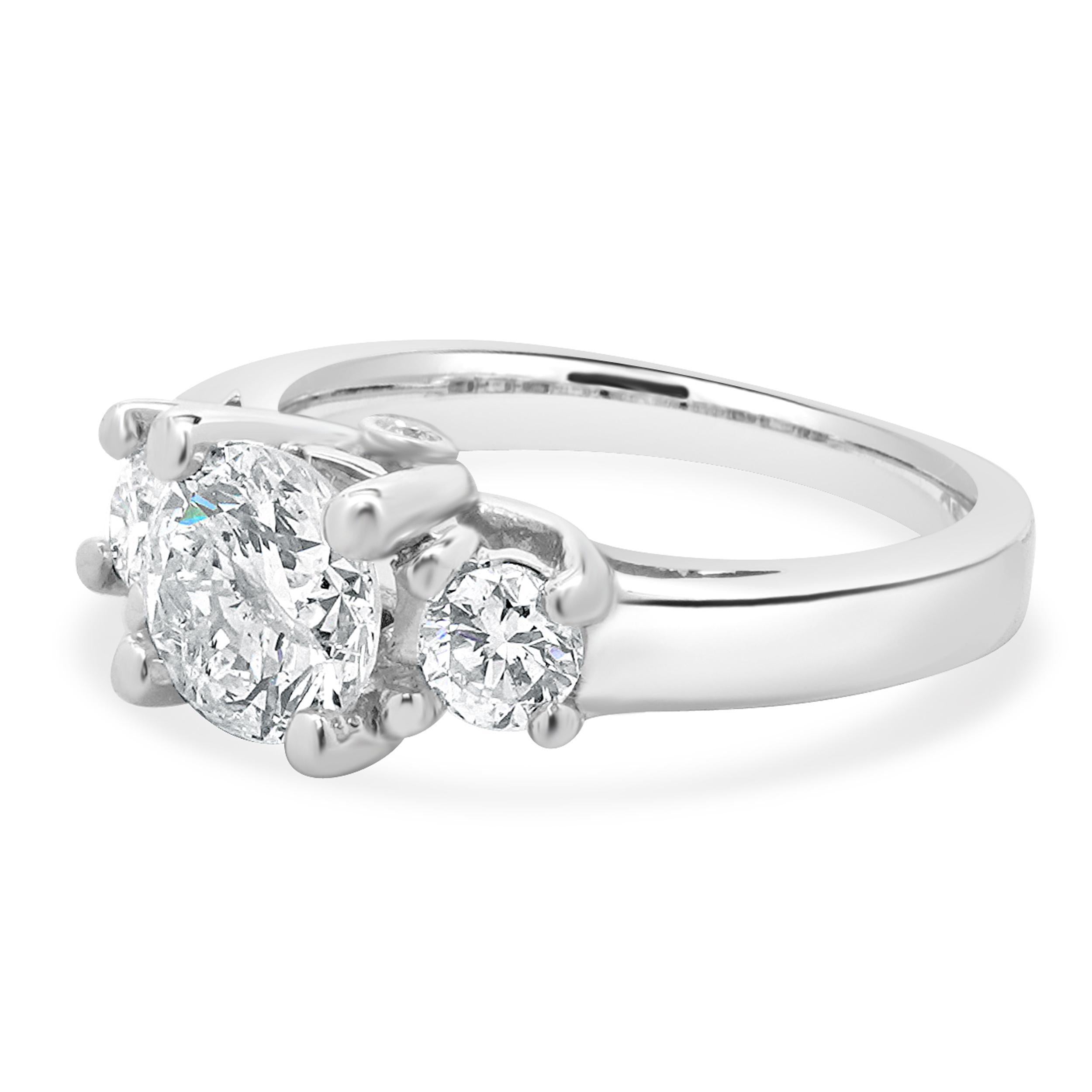 Designer: Custom
Material: 18K white gold
Diamond: 1 round cut = 1.16ct
Color: J
Clarity: SI3
Diamond: 2 round cut = 0.50cttw
Color: H / I
Clarity: SI1
Dimensions: ring top measures 6.8mm wide
Ring Size: 5 (complimentary sizing available)
Weight: