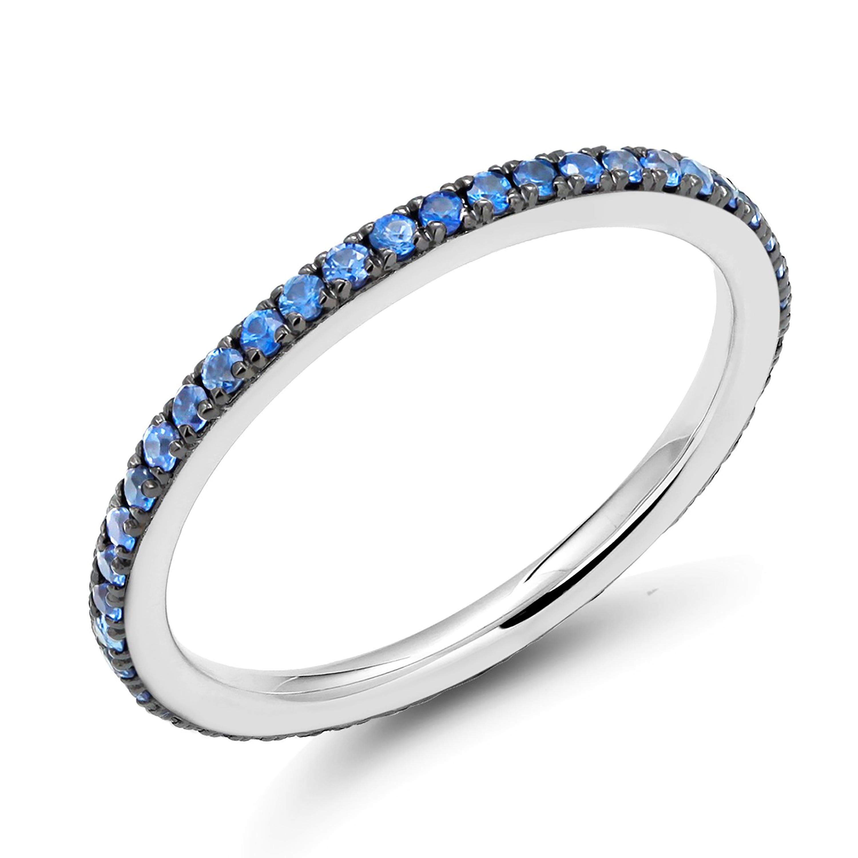 Eighteen karats white gold tiny eternity prong-set stacking band
Sapphires weighing 0.60 carat 
East sapphire measures 1.3 millimeter
The sapphire hue tone color is cobalt blue 
The ring can be worn as an anniversary or stacking band
New Ring
Ring