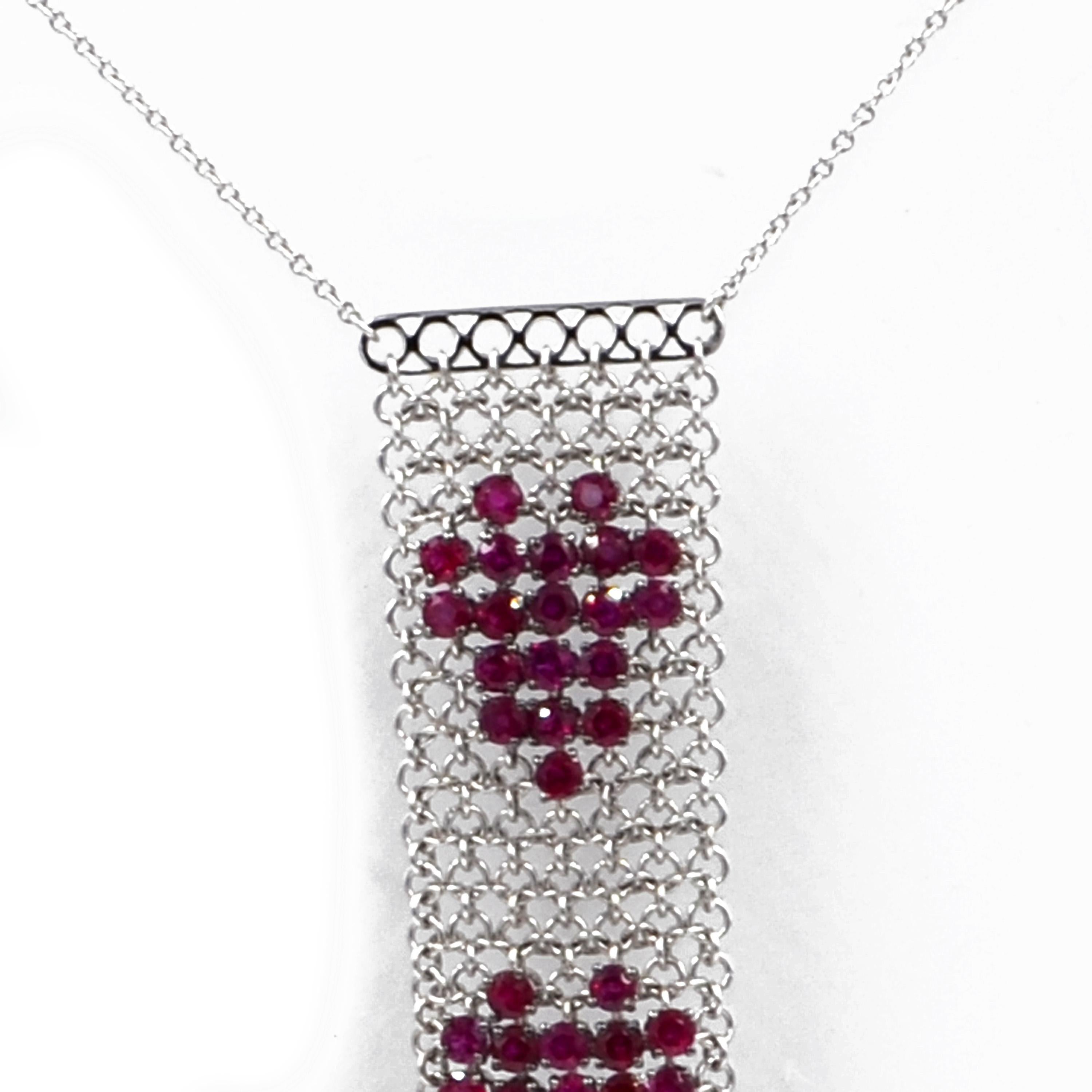 18KT White Gold Hand Made Mesh necklace with two hearts created by beautiful intense red color rubies. Made in Italy by Garavelli  
White diamonds dangling at the bottom of the mesh pendant.
Pendant size mm 85 lenght and 18 width.
Chain total lenght