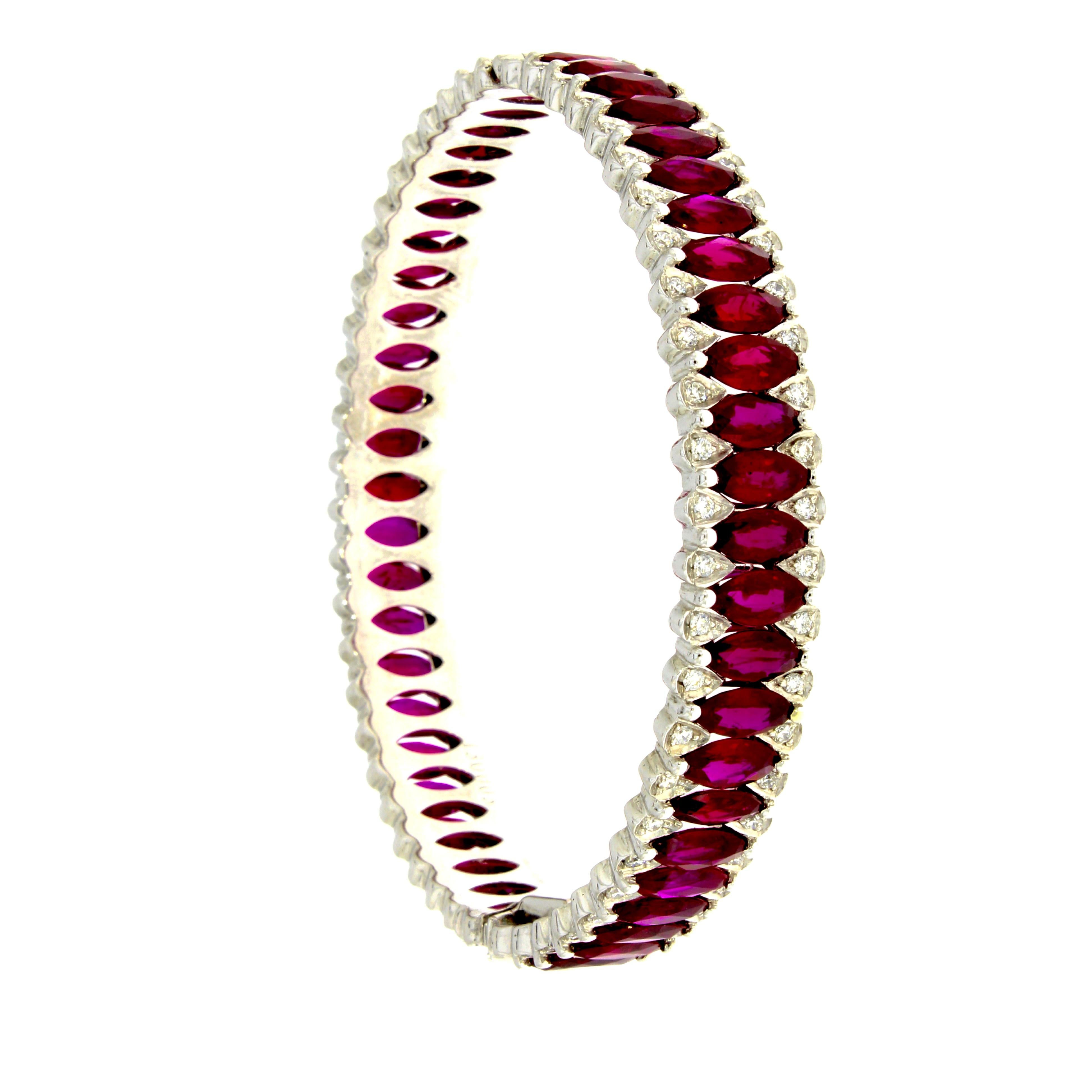 A perpetual circle of vibrant marquise cut rubies poised between two delicate rows of brilliant cut diamonds fluidly wraps around the wrist.

Ruby Amore Eternity Bangle
Details
- 18 karat White Gold
- 20.30 Carat Ruby
- 1.14 carat Diamond

Diameter