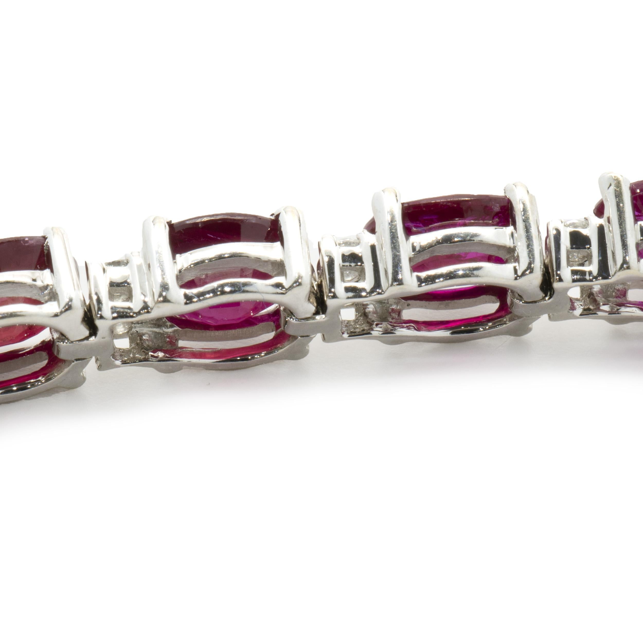 Designer: custom
Material: 18K white gold
Diamond: 42 round brilliant cut = 0.67cttw
Color: I
Clarity: SI2
Ruby: 21 oval cut = 12.80cttw
Weight:  14.40 grams
Dimensions: bracelet will fit up to a 6.5-inch wrist