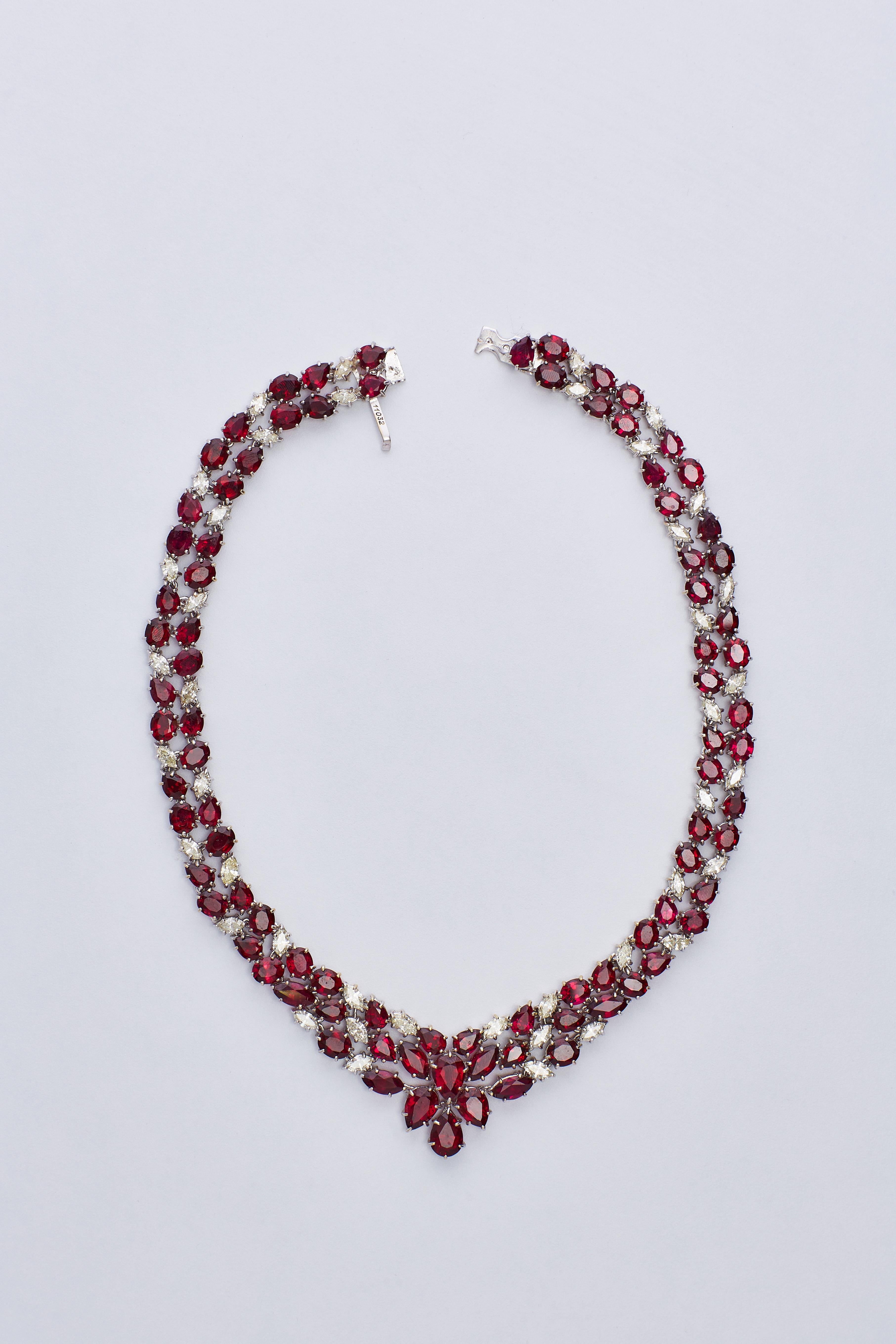 18 Karat White Gold Ruby and Diamond Necklace (Collier)

Incredible collier with 89 Rubies in different sizes and cuts (oval, pear) and 42 Marquise Diamonds.
26 carat of rubies, 28.80 carat of F VS1 diamonds.
Total Weight: 130 grams.