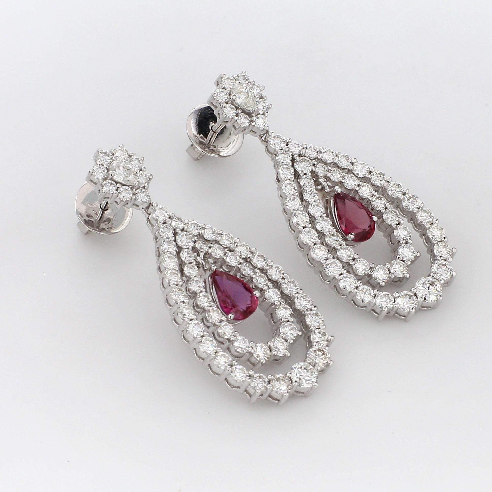 A Beautiful Handcrafted Cocktail Dangle Earring in 18 Karat White Gold with Natural Brilliant Cut Colorless Diamond And  Vibrant Pear No heat Mozambique Rubies. A Statement piece for Evening Wear

Natural Diamond Details
Pieces : 106 Pieces
Weight :