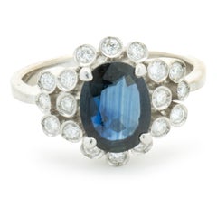 Used 18 Karat White Gold Sapphire and Bezel Set Diamond Ring