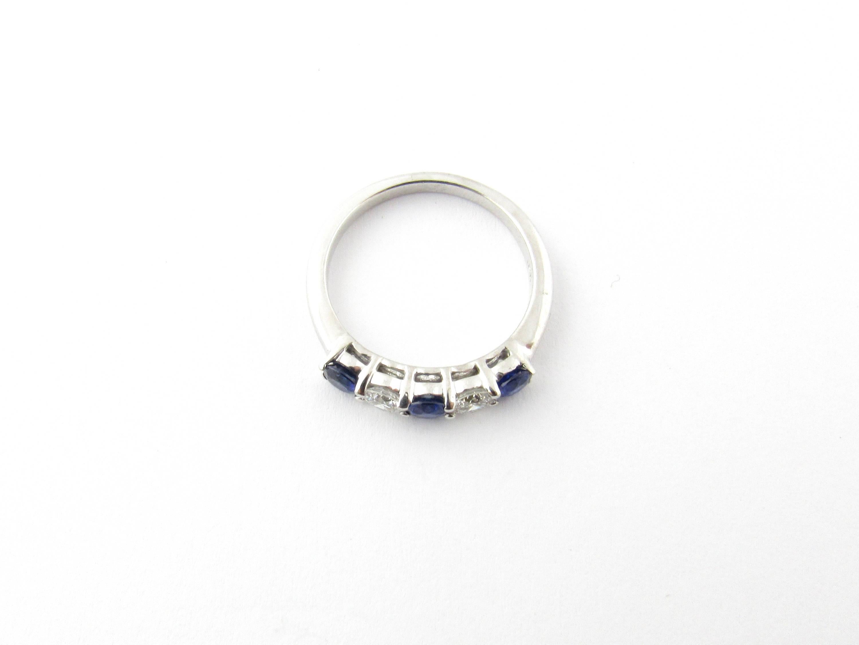 xVintage 18 Karat White Gold Sapphire and Diamond Ring Size 7- 
This sparkling band features three genuine blue sapphires (4 mm each) and two round brilliant cut diamonds (.20 ct. each) set in 18K white gold. Shank measures 2 mm. 
Approximate total
