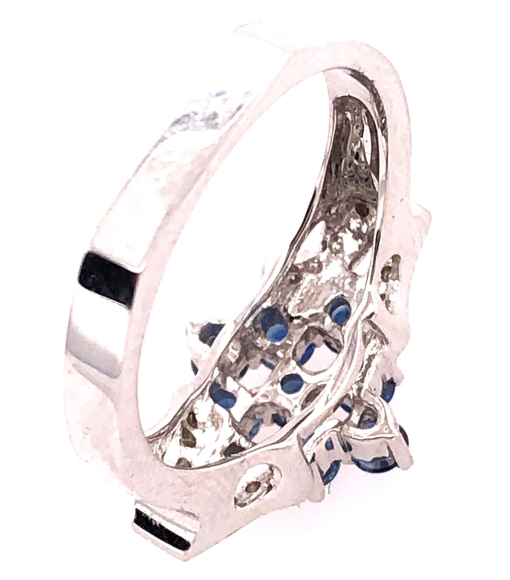 Round Cut 18 Karat White Gold Sapphire Cluster Fashion Ring with Diamond Accents 0.11 TDW For Sale