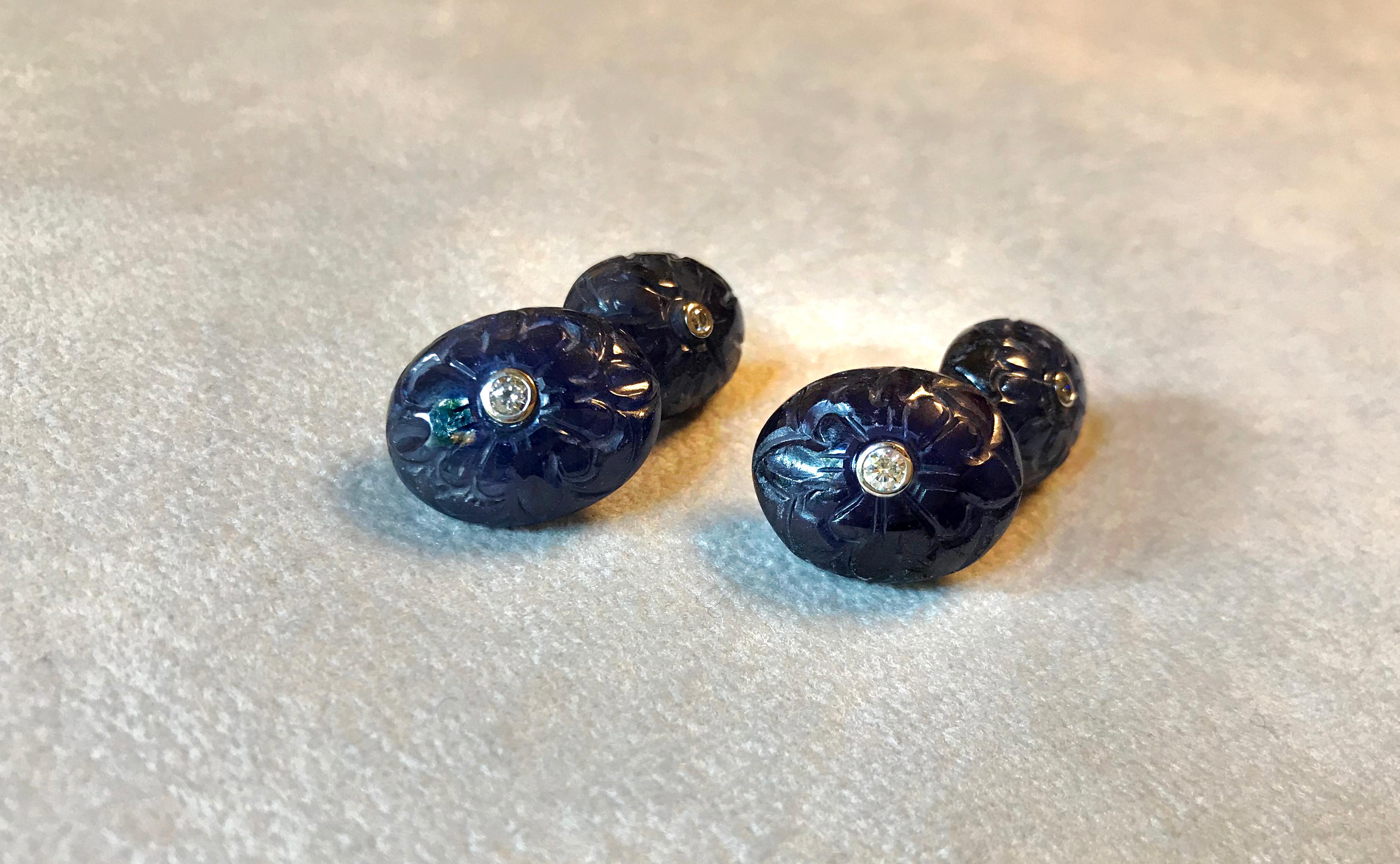 This classic pair of cufflinks is sophisticated and timeless. Both toggle and front face are shaped as ovals made of sapphire that was masterfully carved with an abstract decoration. The center of each element is highlighted with a diamond mounted