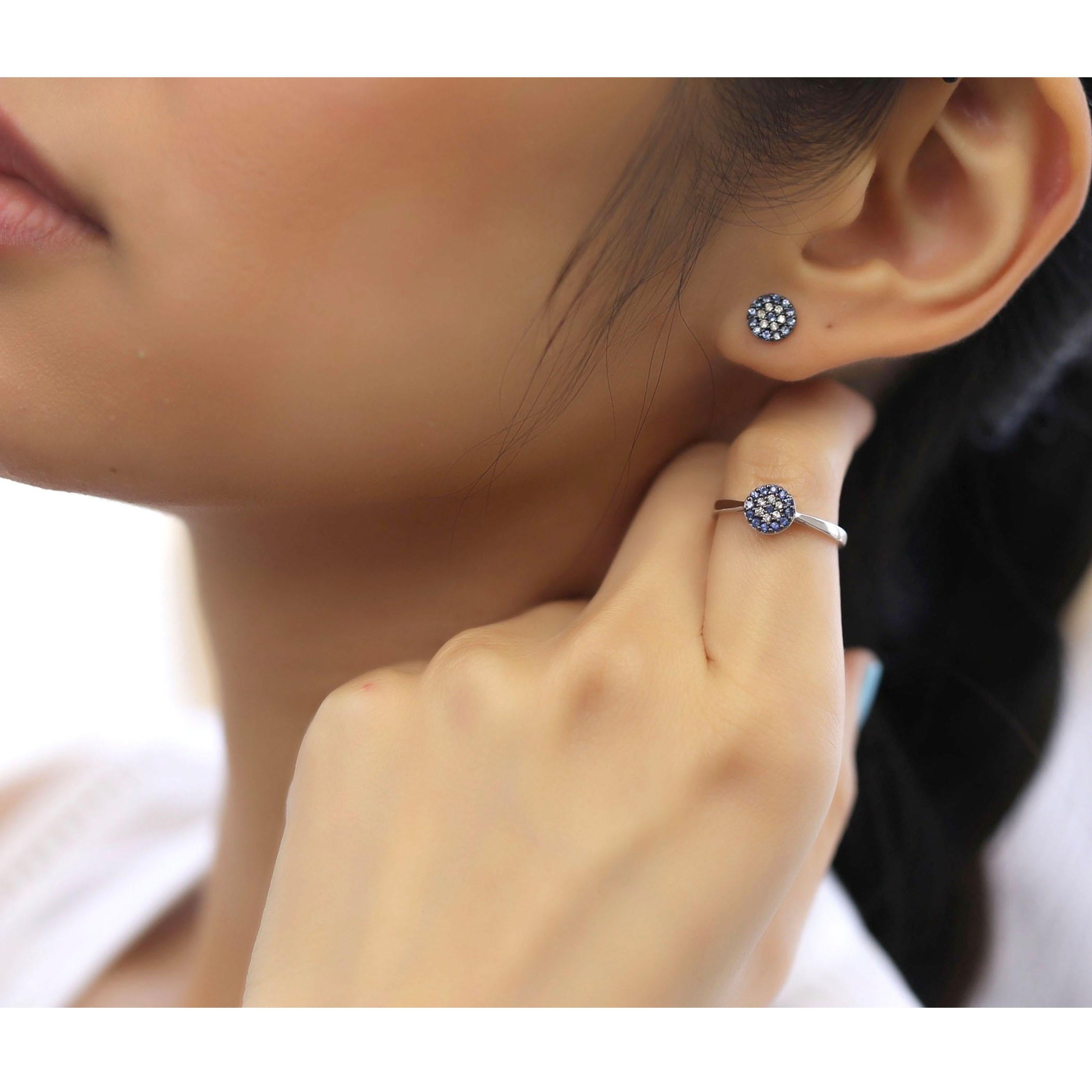 This small flat flower earring and ring set is crafted in 18-karat white gold, weighing approximately 0.14 total carats of SI-H Quality white diamonds and 0.35 total carats of sapphire stones. The ring is comfortable and can be sized 