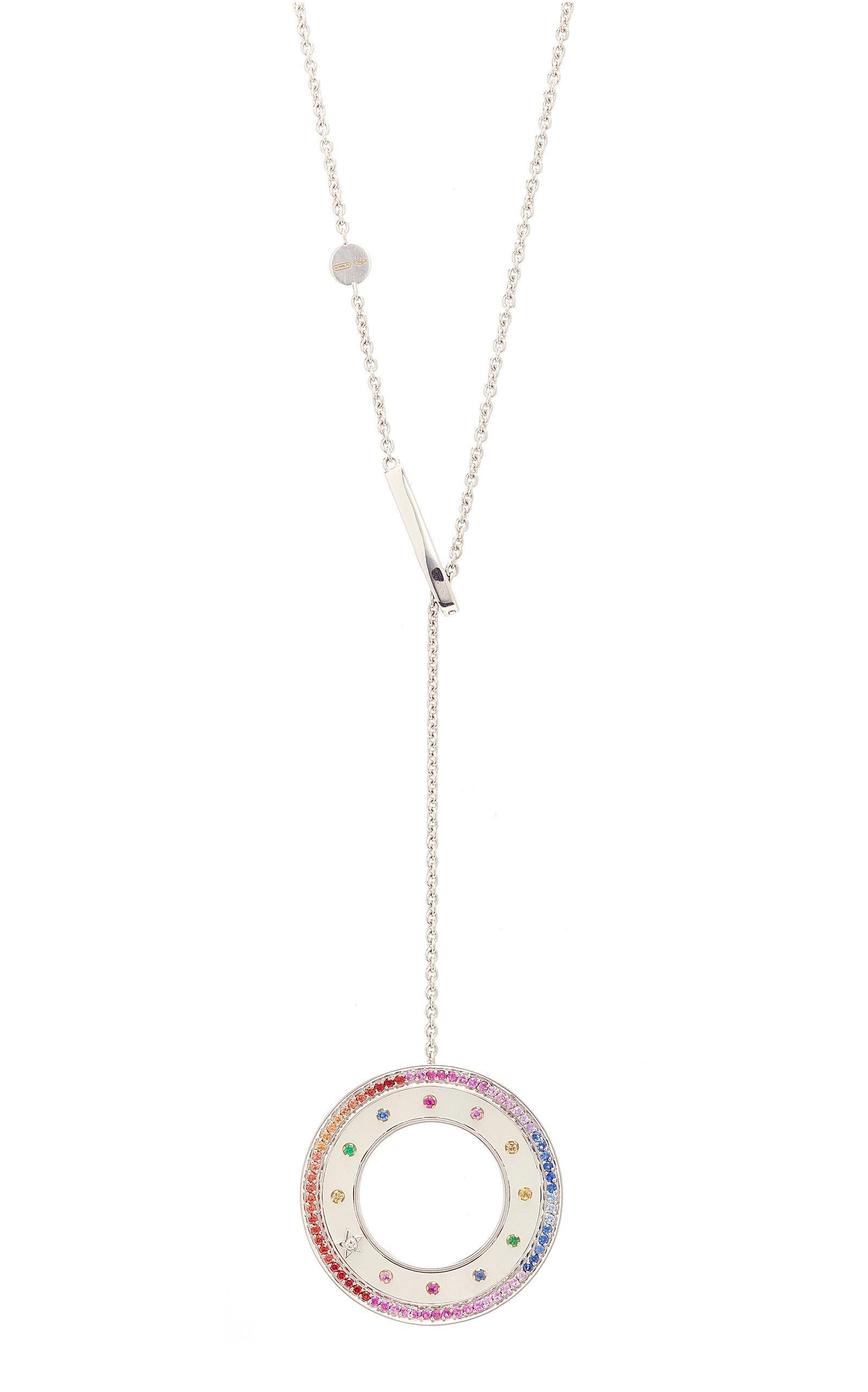 Anna Maccieri Rossi's 'ORA Rainbow Pendant' features a circular pendant where the concept of time is emphasized by the sequence and rhythm of the multicolored sapphires. The hours of the day are marked by multicolored sapphires and diamond star at 8