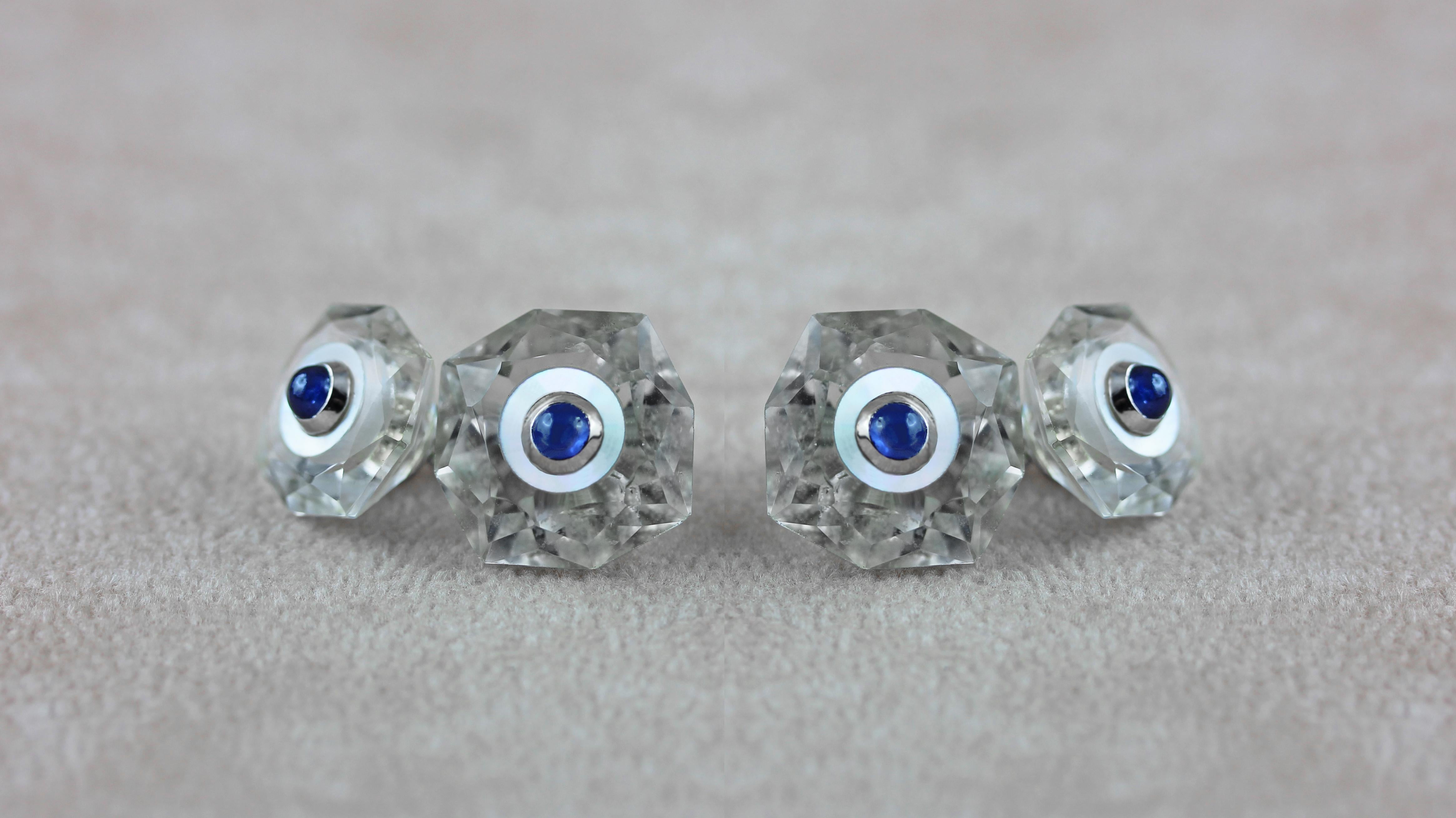 These octagonal cufflinks are made of rock crystal, whose delicate shade highlights the octagonal, multifaceted silhouette of both front face and toggle. 
The center of each piece is decorated with mother of pearl and a cabochon sapphires set in 18